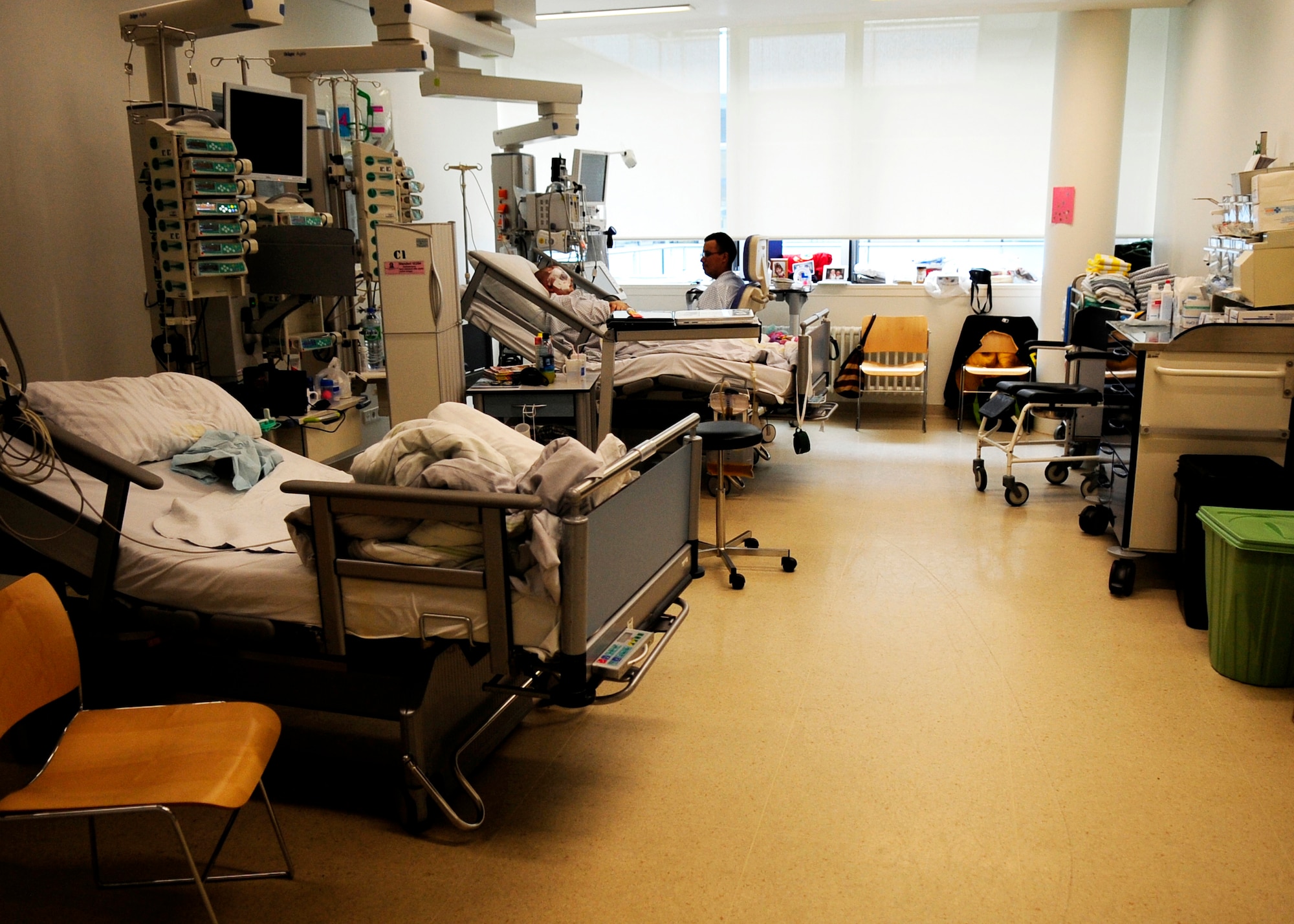 Staff Sgt. Kris Schneider and Senior Airman Edgar Veguilla, 48th Security Forces Squadron, take advantage of the quiet to talk with each other in their room at the Johann Wolfgang Goethe University Hospital in Frankfurt am Main, Germany. The RAF Lakenheath Airmen were being treated for injuries sustained during the March 2, 2011, shooting at the Frankfurt International Airport. (U.S. Air Force photo by Tech. Sgt. Jocelyn L. Rich)