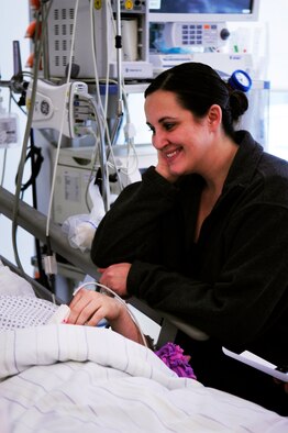 Amanda Schneider talks with her husband Staff Sgt. Kris Schneider as he recovers from injuries sustained during the March 2, 2011, shooting at the Frankfurt International Airport, Germany. Schneider, now retired and residing in Grand Forks, N.D., gave an inspirational speech on his life since the shooting to members of the local community alongside Amanda Jan. 10, 2013. (U.S. Air Force photo/Tech. Sgt. Jocelyn L. Rich)