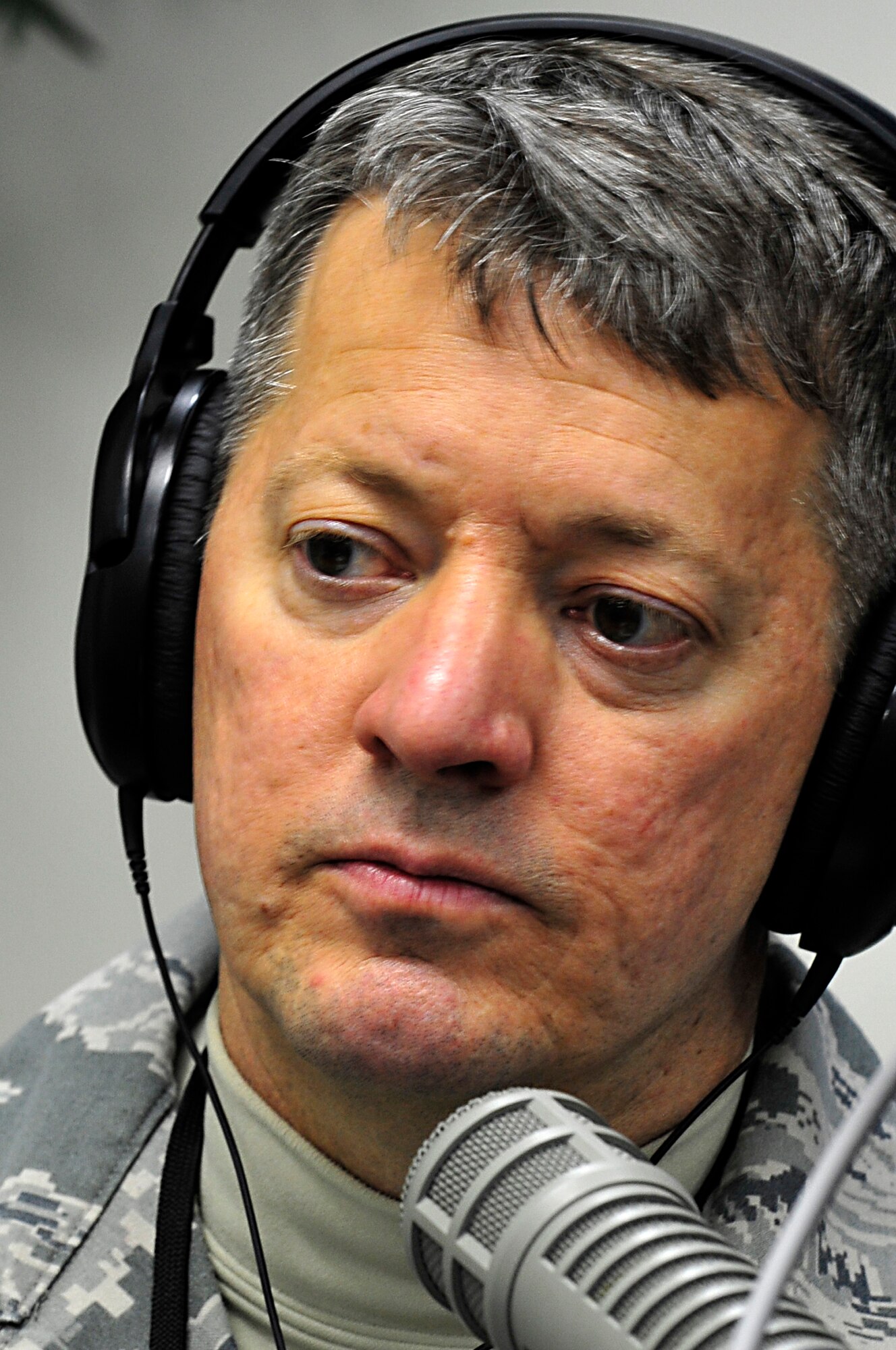 MISAWA AIR BASE, Japan -- Chief Master Sgt. Russell Hastings, 35th Fighter Wing command chief, listens to a caller over the Armed Forces Network Mar. 18. Base personnel can ask questions regarding concerns that they may have by e-mail or calling 226-1575 during the radio show at the end of the month. (U.S. Air Force photo by Staff Sgt. Marie Brown\Released)