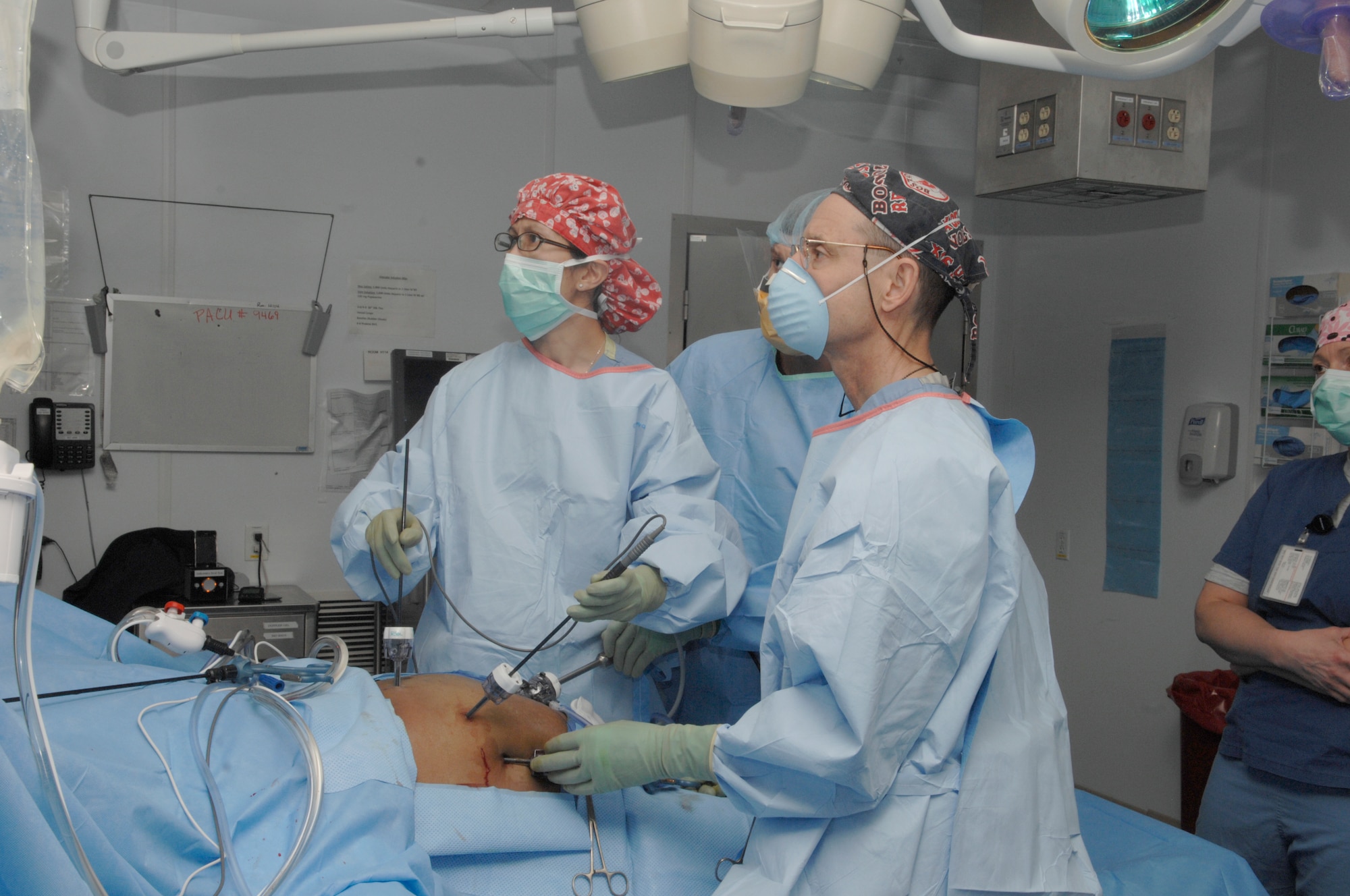 Army Lt. Col. Rob Sheridan, Navy Lt. William Ward and Air Force Maj. Kullie Pichakron, all surgeons at Craig Joint Theater Hospital, perform a cholecystectomy on a patient. The operating room at CJTH is the most advanced in the U.S. Central Command. (U.S. Air Force photo/Senior Airman Amber R. Kelly-Herard)