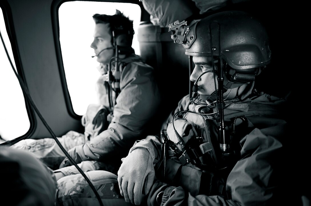 YOKOTA AIR BASE, Japan -- Combat controllers with the 320th Special Tactics Squadron from Kadena Air Base, Japan, fly in an HH-60G Pave Hawk on their way to Sendai, Japan, March 15. The 320th STS has combat controllers, pararescuemen and special operations weather teams to go anywhere and set up forward operating locations and impromptu runways. (U.S. Air Force photo/Staff Sgt. Samuel Morse)