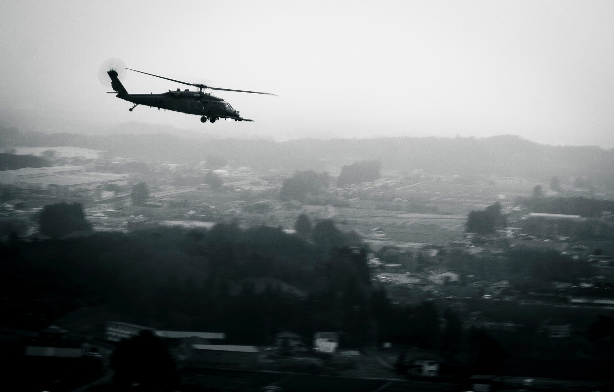 YOKOTA AIR BASE, Japan -- An HH-60G Pave Hawk flies over the Japanese countryside carrying members of the 320th Special Tactics Squadron from Kadena Air Base March 15. The 320th STS has combat controllers, pararescuemen and special operations weather teams to go anywhere and set up forward operating locations and impromptu runways. (U.S. Air Force photo/Staff Sgt. Samuel Morse)