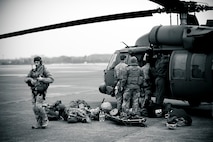 YOKOTA AIR BASE, Japan -- Members of the 320th Special Tactics Squadron from Kadena Air Base, Japan, load an HH-60G Pave Hawk here March 15. The 320th STS has combat controllers, pararescuemen and special operations weather teams to go anywhere and set up forward operating locations and impromptu runways. (U.S. Air Force photo/Staff Sgt. Samuel Morse)