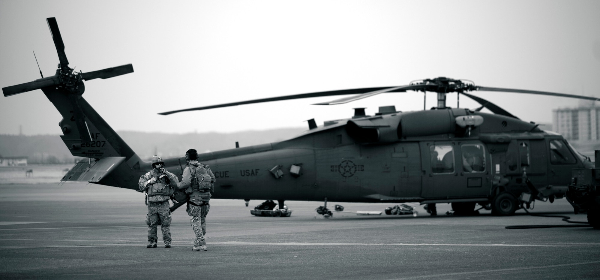 YOKOTA AIR BASE, Japan -- Two team leads from the 320th Special Tactics Squadron from Kadena Air Base, Japan, discuss the upcoming mission before boarding an HH-60G Pave Hawk here March 15. The 320th STS has combat controllers, pararescuemen and special operations weather teams to go anywhere and set up forward operating locations and impromptu runways. (U.S. Air Force photo/Staff Sgt. Samuel Morse)