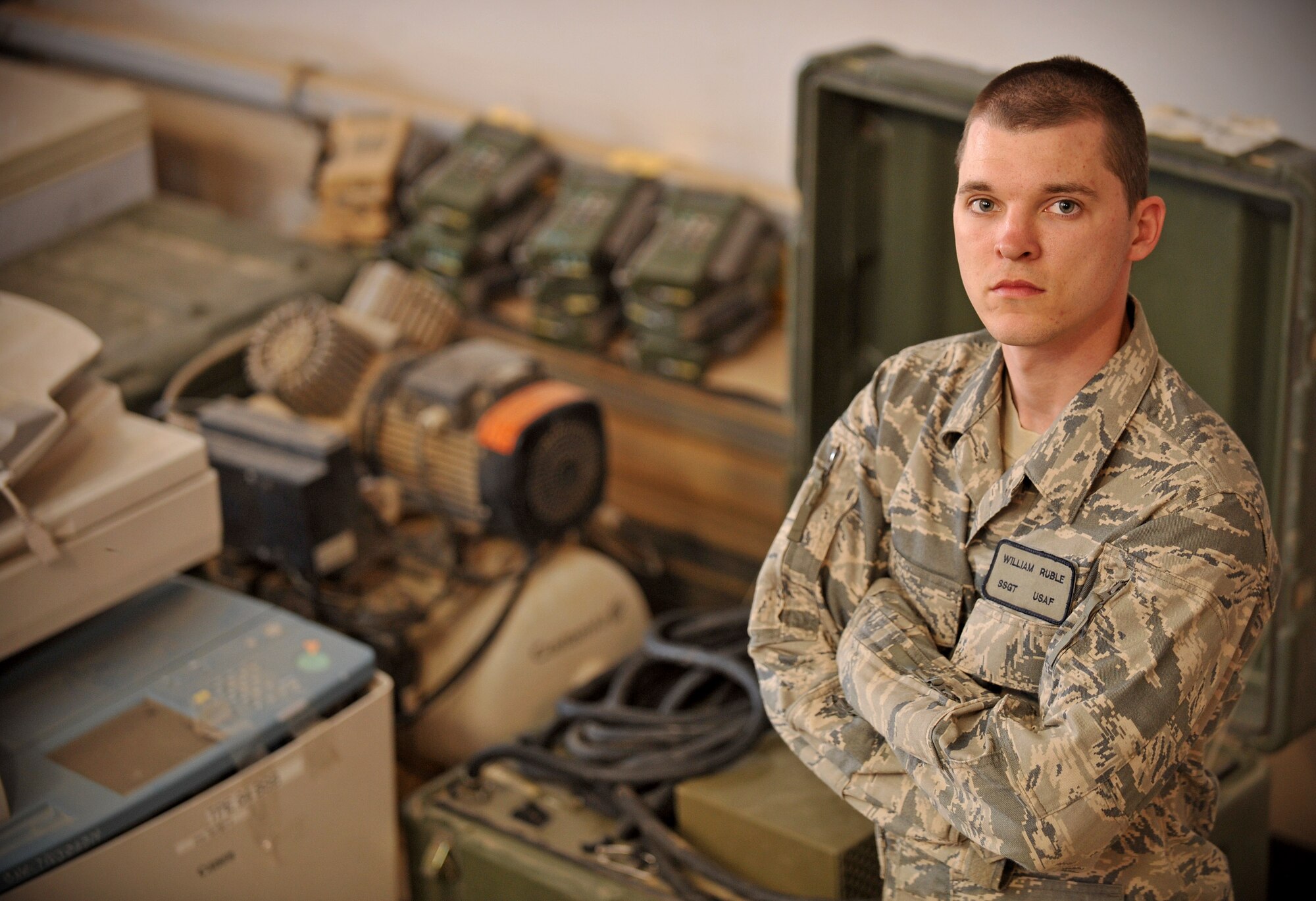 Staff Sgt. William Ruble, Tallil redistribution property assistance team's non-rolling stock NCO in charge, poses for a photo in front of equipment from the non-rolling stock section March 5, 2011, at Ali Air Base, Iraq. Sergeant Ruble is a native of Irvine, Ky. (U.S. Air Force photo by Senior Airman Andrew Lee/Released) 