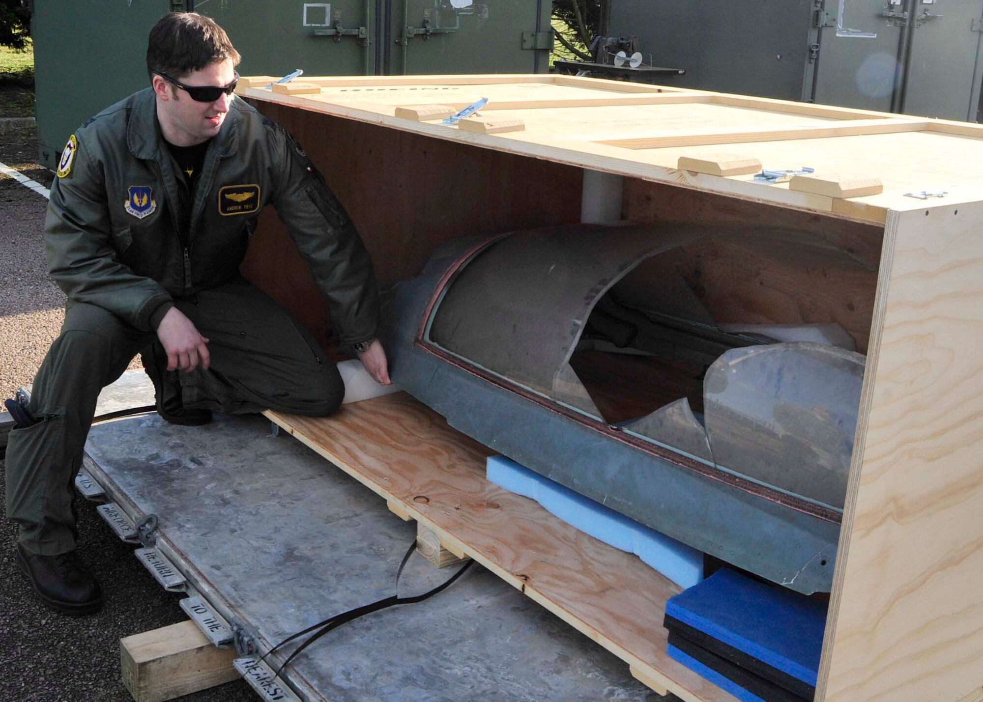 ROYAL AIR FORCE LAKENHEATH, England -- Capt. Michael Frye, 493rd Fighter Squadron F-15C Eagle pilot, pulls the recovered canopy of a MiG-29 from a crate outside the 493rd FS building on Jan. 29. The canopy came from a Serbian jet that had been shot down during Operation Allied Force. (U.S. Air Force photo/Senior Airman Tiffany M. Deuel)