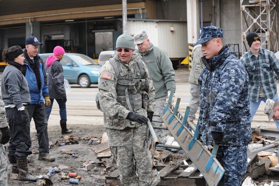 MISAWA AIR BASE, Japan - Joining forces to help with the relief efforts of the Hachinoe recovery, soliders, sailors and airmen come together and lend a helping hand to get the job done on March 17.  The Japanese town of Hachinoe suffered massive damage after the tusnami rushed through the town.  (U.S. Air Force Staff Sgt. April Quintanilla)