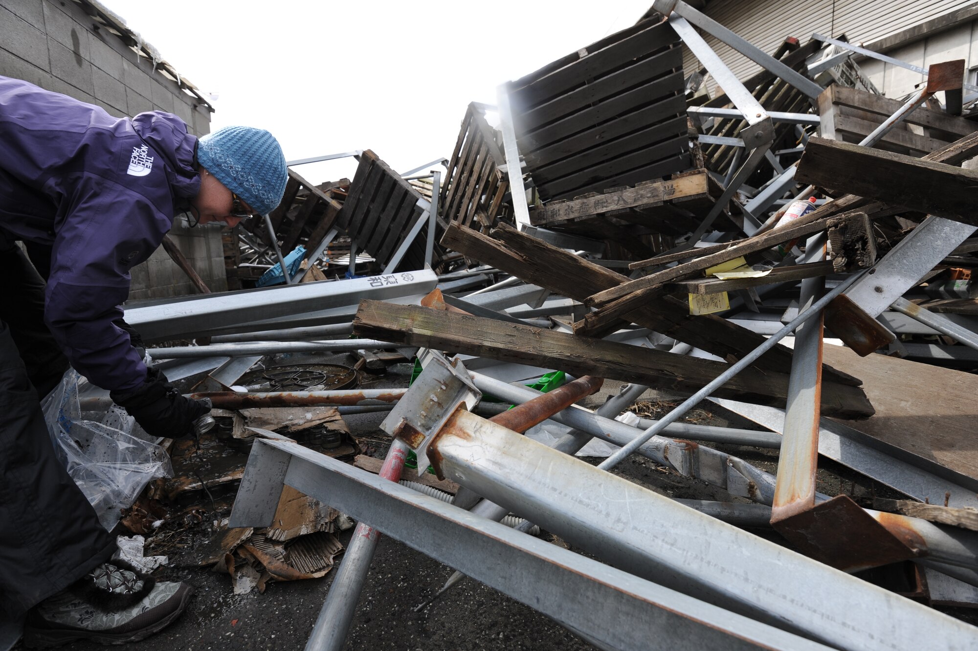 MISAWA AIR BASE, Japan - Kendall Nations, wife of Capt. Nations 14th Fighter Squadron, volunteers to help with the recovery efforts in the town of Hachinohe, Japan March 17.  Hachinohe suffered massive damage due to the recent tsunami that came after the 9.1 earth quake on March 11.  (U.S. Air Force Staff Sgt. April Quintanilla)