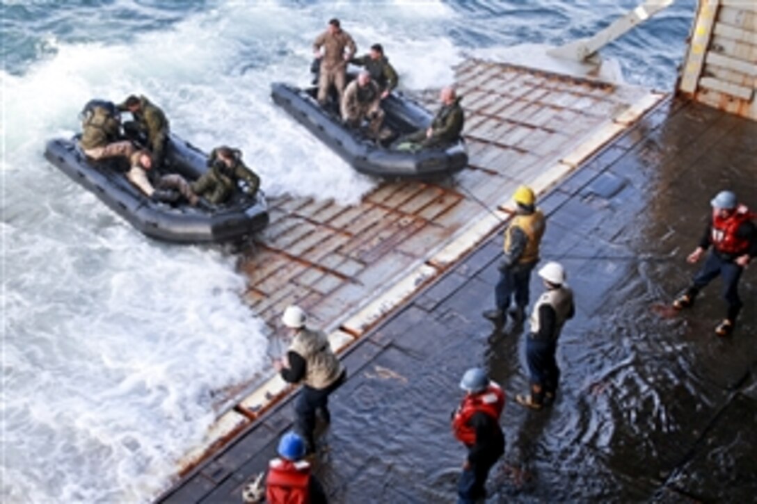 U.S. Marines in zodiak boats conduct training with sailors on the stern gate of the amphibious dock landing ship USS Gunston Hall off the coast of North Carolina in the Atlantic Ocean, March 15, 2011. 