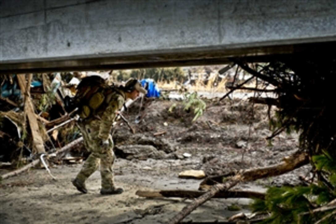 U.S. Air Force Senior Airman Steven Nizbet looks for trapped survivors in Sendai, Japan, March 16, 2011. Members of the 320th Special Tactics Squadron stationed out of Kadena Air Base deployed to Sendai Airport to help clear the runway and make it ready for fixed-wing aircraft traffic. Nizbet is a pararescueman assigned to the 320th Special Tactics Squadron.