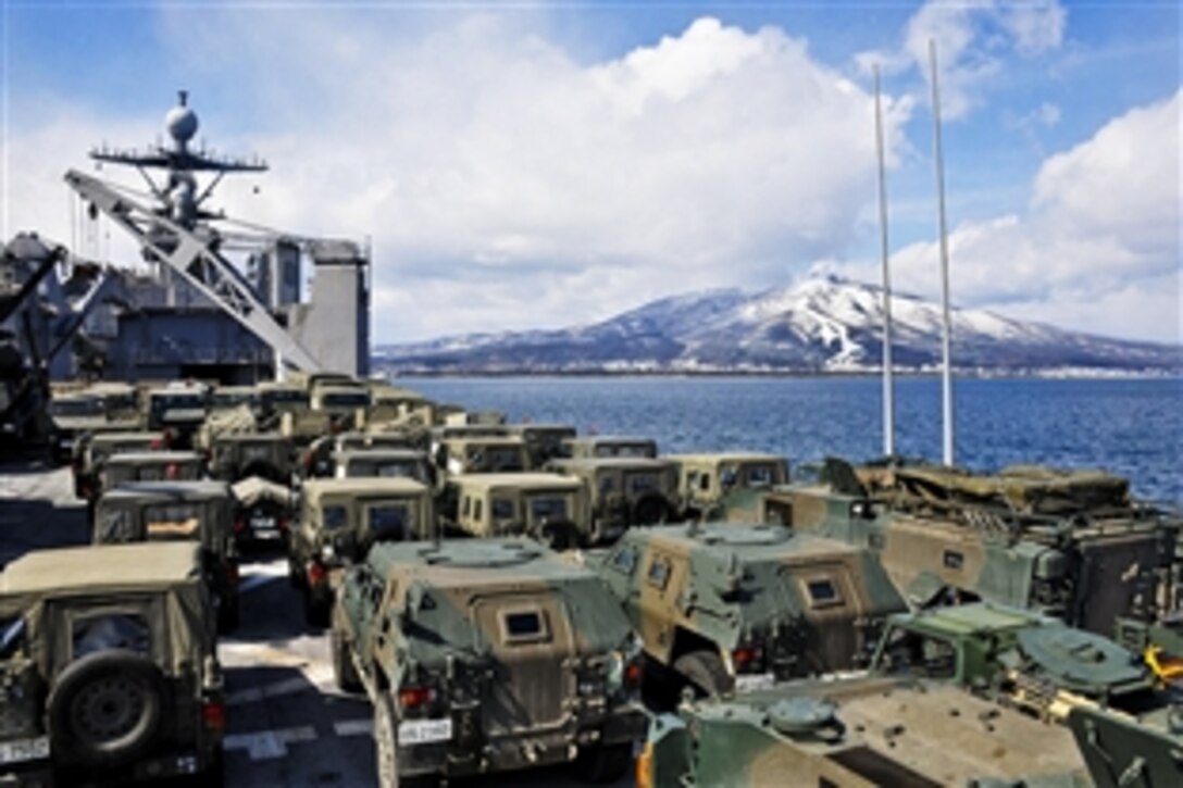 The USS Tortuga loaded with Japan Ground Self Defense Force vehicles anchors near Mount Kamafuse off Ominato, Japan, March 17, 2011. U.S. and Japanese landing craft worked together to get military vehicles and personnel from Tomakomai in Hokkaido to Ominato in northern Honshu as part of earthquake relief efforts.