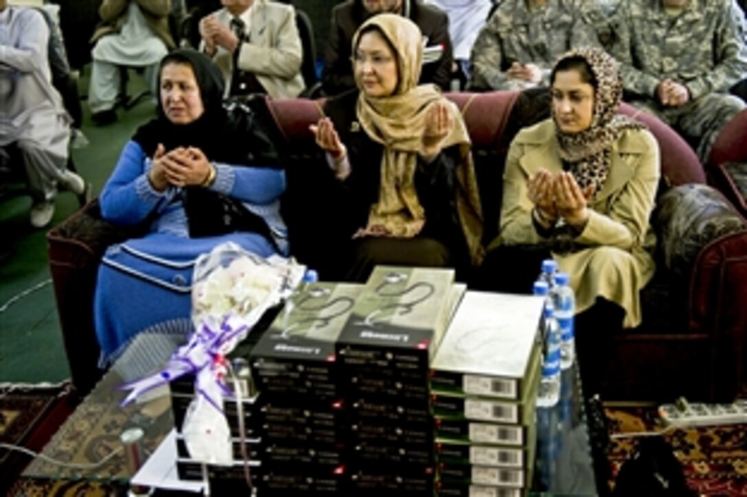 Participants recite a closing prayer at the first-ever medical conference in Afghanistan's Zabul province, March 17, 2011. The conference was held to educate Afghan doctors and midwives on current medical procedures, and how to better improve the Afghan health system. U.S. service members provided security for the event.