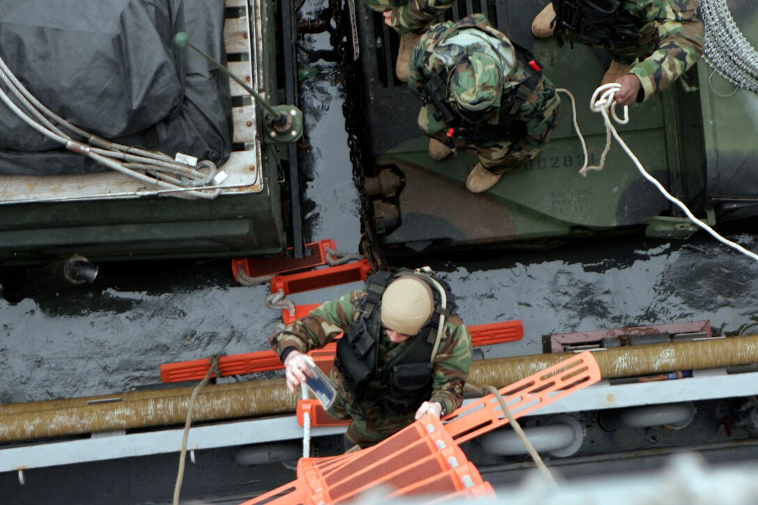 A Sailor climbs a ladder from a landing craft utility after loading supplies and equipment from the 31st Marine Expeditionary Unit. The LCU was loaded in preparation for humanitarian aid and disaster relief operations in Japan. Navy and Marine Corps involvement is part of a larger U.S. government response, coordinated through the U.S. Department of State, after a 9.0 earthquake and subsequent tsunami struck Japan causing widespread damage. As part of Operation Tomodachi, the 31st MEU is ready to support our Japanese partners and to provide assistance when called upon.