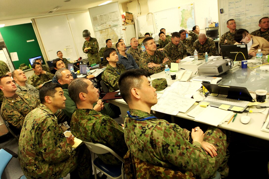 The Information Cell conducts a bilateral meeting March 19 here. Service members with United States Forces Japan and Japanese North East Army coordinate information for planning humanitarian assistance and disaster relief for the Japanese surrounding communities affected by the earthquake and tsunami March 11.