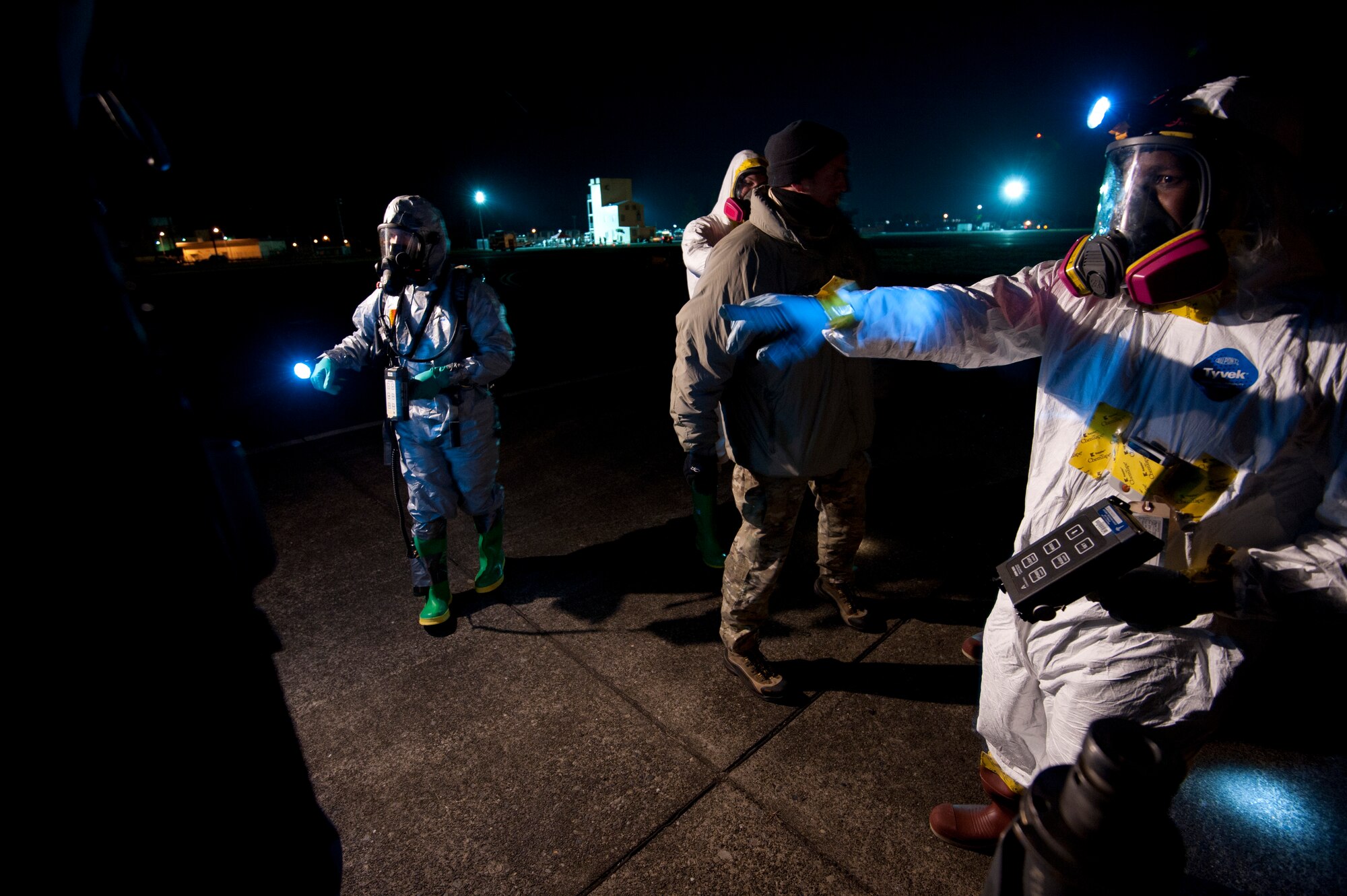 YOKOTA AIR BASE, Japan--Members of the Contamination Avoidance Team screen aircraft and aircrew members returning from a flight to Northern Japan.  The team is composed of experts from the 374th Aerospace Medicine Squadron's bioenvironmental engineering flight and 374th Civil Engineer Squadron's readiness flight.  (U.S. Air Force photo/Staff Sgt. Samuel Morse)