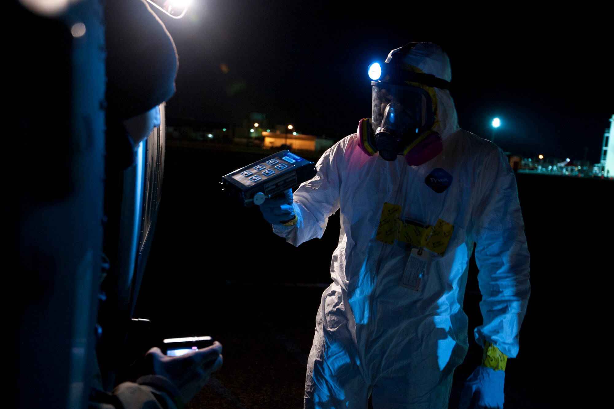 YOKOTA AIR BASE, Japan--A member of the Contamination Avoidance Team uses an ADM-300 to screen aircraft and aircrew members returning from a flight to Northern Japan.  The team is composed of experts from the 374th Aerospace Medicine Squadron's bioenvironmental engineering flight and the 374th Civil Engineer Squadron's readiness flight.  (U.S. Air Force photo/Staff Sgt. Samuel Morse)