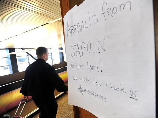 Military personnel and family members from Japan are directed to the USO at the Seattle-Tacoma International Airport, Wash., on March 19, 2011. About 240 servicemembers and their families landed at the airport in the first wave of more than 6,000 returning from Japan. (U.S. Air Force Photo)