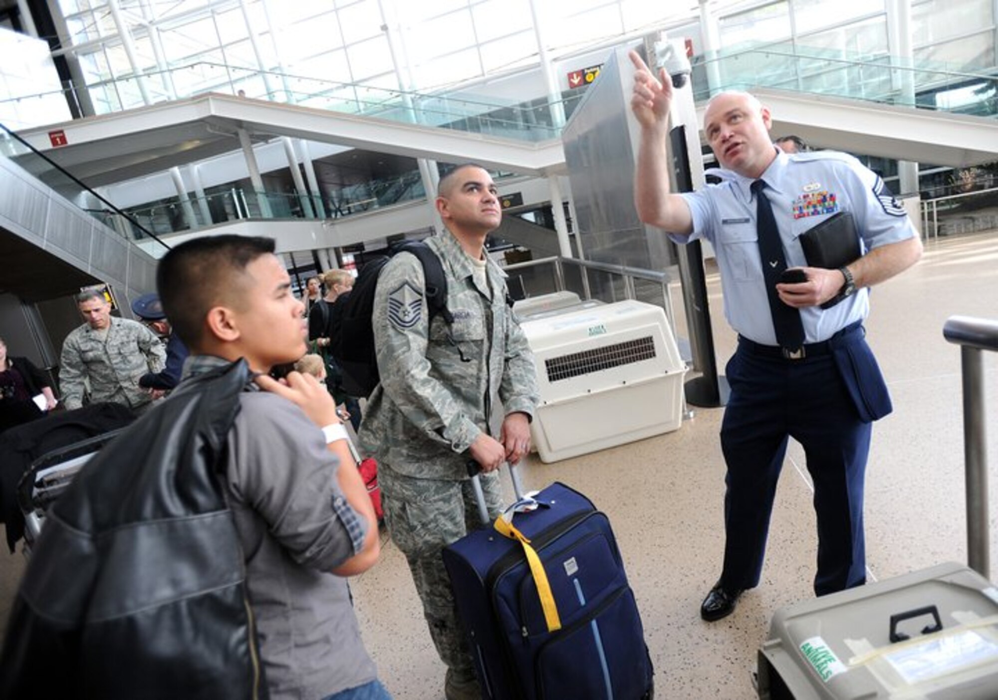 Senior Master Sgt. Robert Childress, right, directs family members from Japan to the Seattle-Tacoma International Airport USO March 19, 2011. About 240 servicemembers and their families landed at Sea-Tac in what is to be the first wave of more than 6,000 evacuees from Japan.