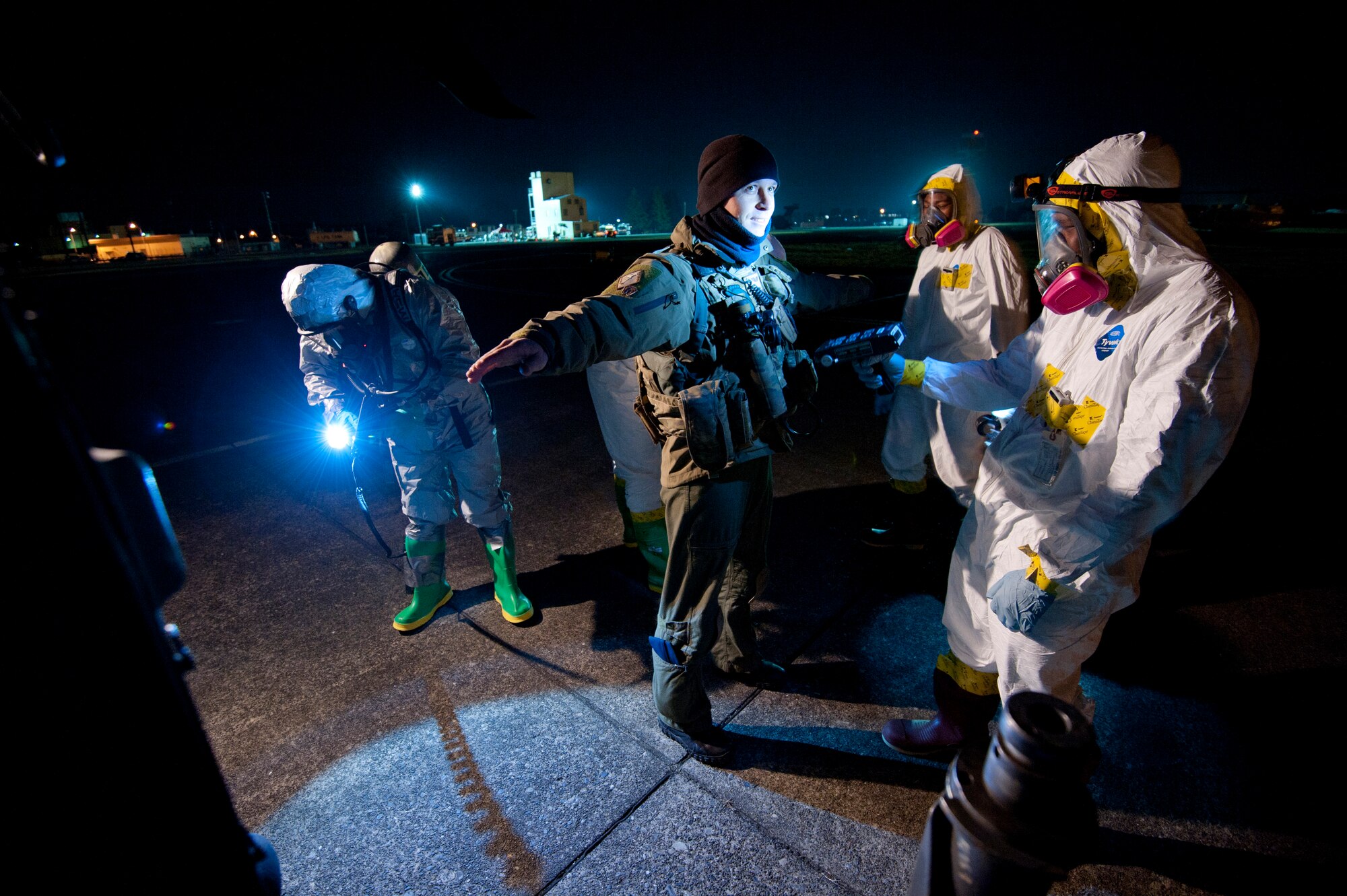 YOKOTA AIR BASE, Japan -- Tech. Sgt. Michael Welles, 33rd Rescue Squadron aerial gunner, is checked for contamination by 374th Aerospace Medicine Squadron bioenvironmental engineers and 374th Civil Engineer Squadron emergency management flight members here March 13. (U.S. Air Force photo/Staff Sgt. Samuel Morse)