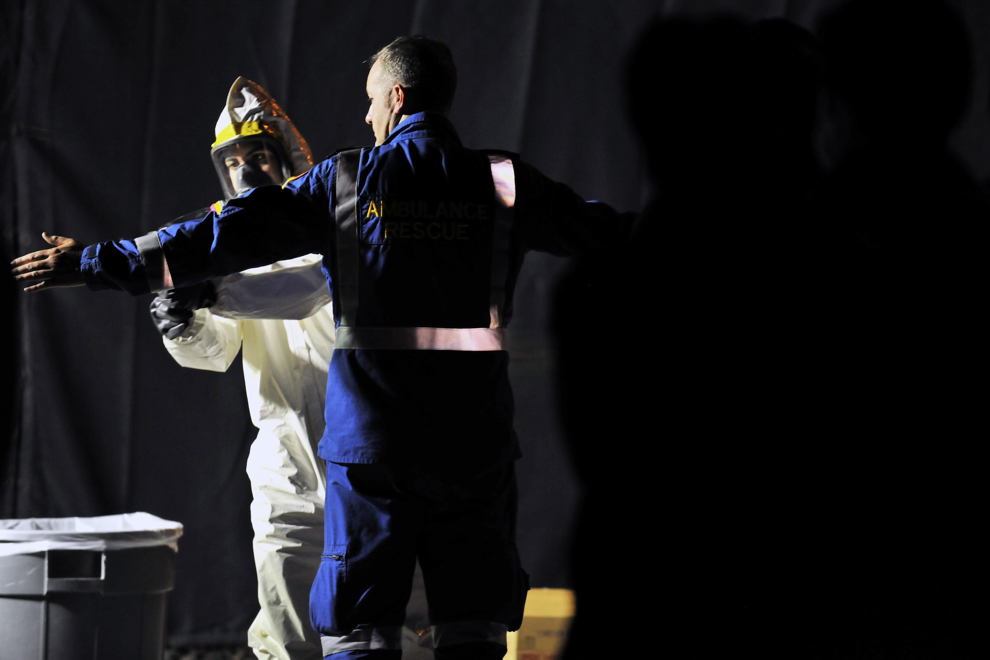 YOKOTA AIR BASE, Japan --  Senior Airman Jonathan Jones, 374th Civil Engineer Squadron, scans a member of the Queensland Urban Search and Rescue Taskforce for contamination here March 20. The team just returned from a week long  search and rescue mission in Myagi. (U.S. Air Force photo/Master Sgt. Kimberly Spinner) 