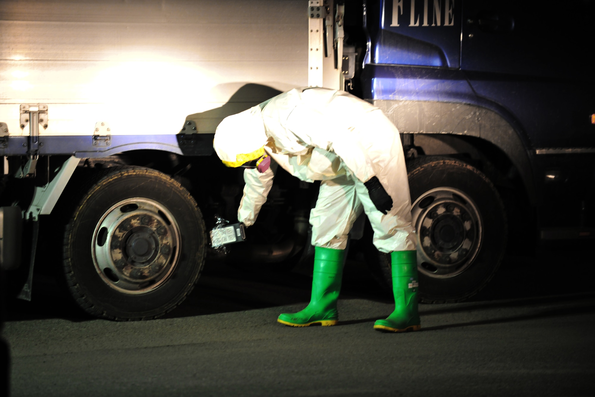 YOKOTA AIR BASE, Japan --  An Airman scans a vehicle for contamination here March 20. The truck was part of a convoy that that just returned from a search and rescue mission in Myagi. (U.S. Air Force photo/Master Sgt. Kimberly Spinner) 