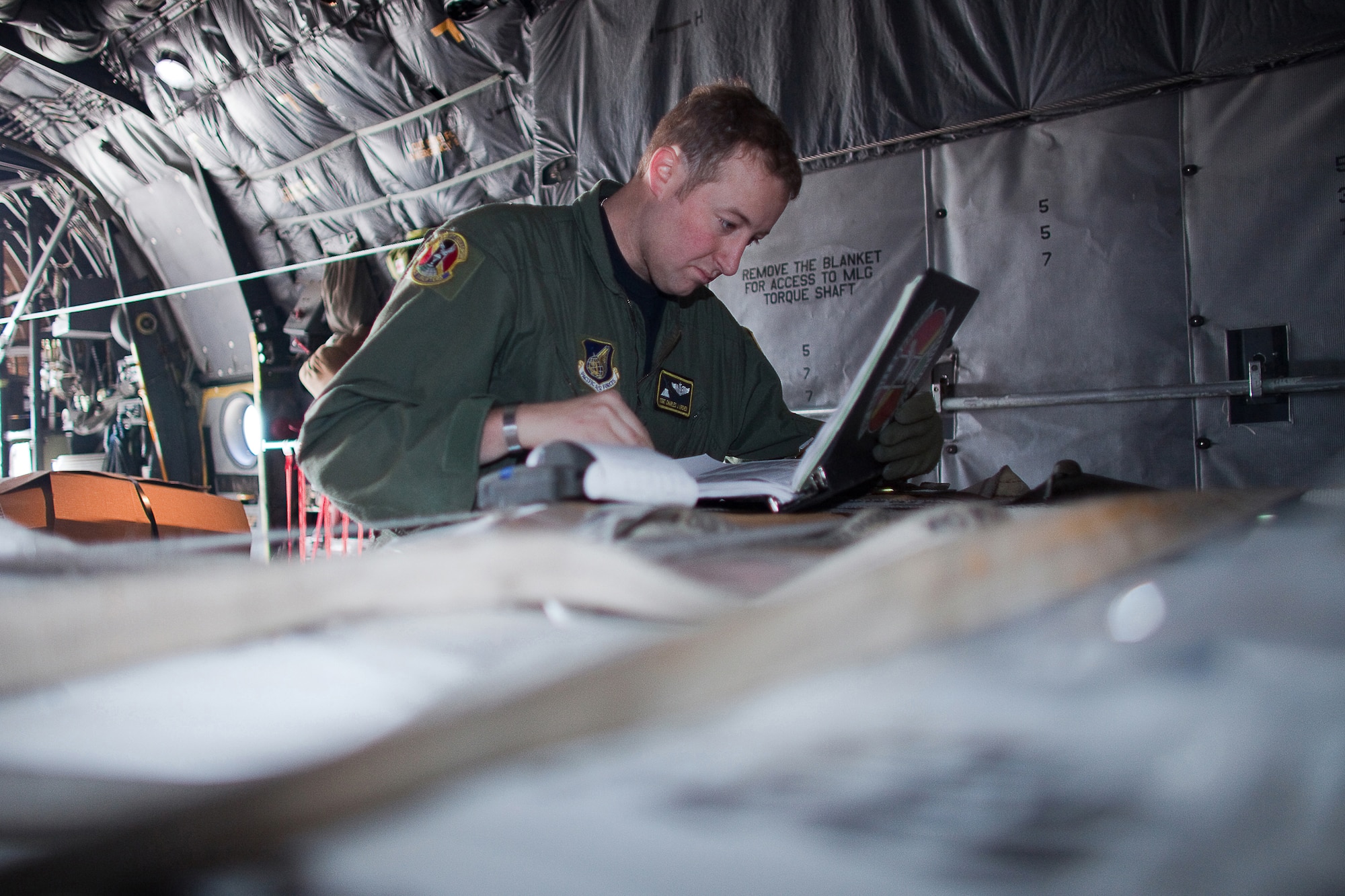 YOKOTA AIR BASE, Japan -- Staff Sgt. Charles Kirchen, 36th Airlift Squadron, inspects pallets of boron onto a C-130 Hercules, before departing for Hyakuri Air Base March 19. Japanese forces will use the boron to aid stabilization efforts at the Fukushima Daiichi nuclear plant. (U.S. Air Force photo/Osakabe Yasuo)