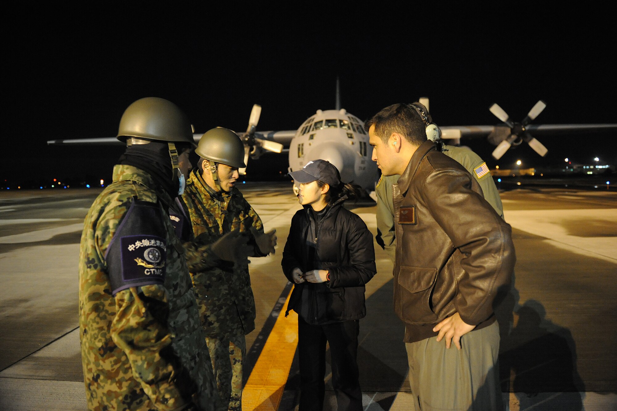 HANAMAKI, Japan -- Japan Self Defense Forces members communicate with Dr. Maya Arii and Capt Aron Pena, 36th Airlift Squadron, about downloading medical supplies from a C-130H Hercules March 19. The medical supplies were flown to Sendai and Hanamaki Airport to be distributed to local hospitals and evacuation centers as part of Operation Tomodachi.  (U.S. Air Force photo/Staff Sgt. Jonathan Steffen)