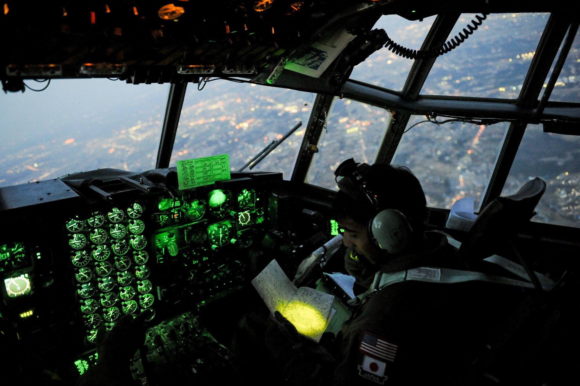 YOKOTA AIR BASE, Japan -- Capt. Yuri Batten, 36th Airlift Squadron, looks at a map March 19 while flying on a C-130H Hercules full of medical supplies. The medical supplies were flown to Sendai and Hanamaki Airport to be distributed to local hospitals and evacuation centers as part of Operation Tomodachi. (U.S. Air Force photo/Staff Sgt. Jonathan Steffen)