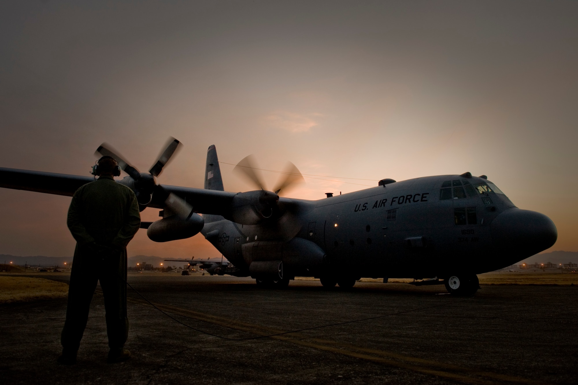 YOKOTA AIR BASE, Japan -- Staff Sgt. Charles Kirchen, 36th Airlift Squadron, watches as the engines start up on a C-130H Hercules March 19 before a mission. Medical supplies were flown to Sendai and Hanamaki Airport to be distributed to local hospitals and evacuation centers as part of Operation Tomodachi.  (U.S. Air Force photo/Staff Sgt. Jonathan Steffen)