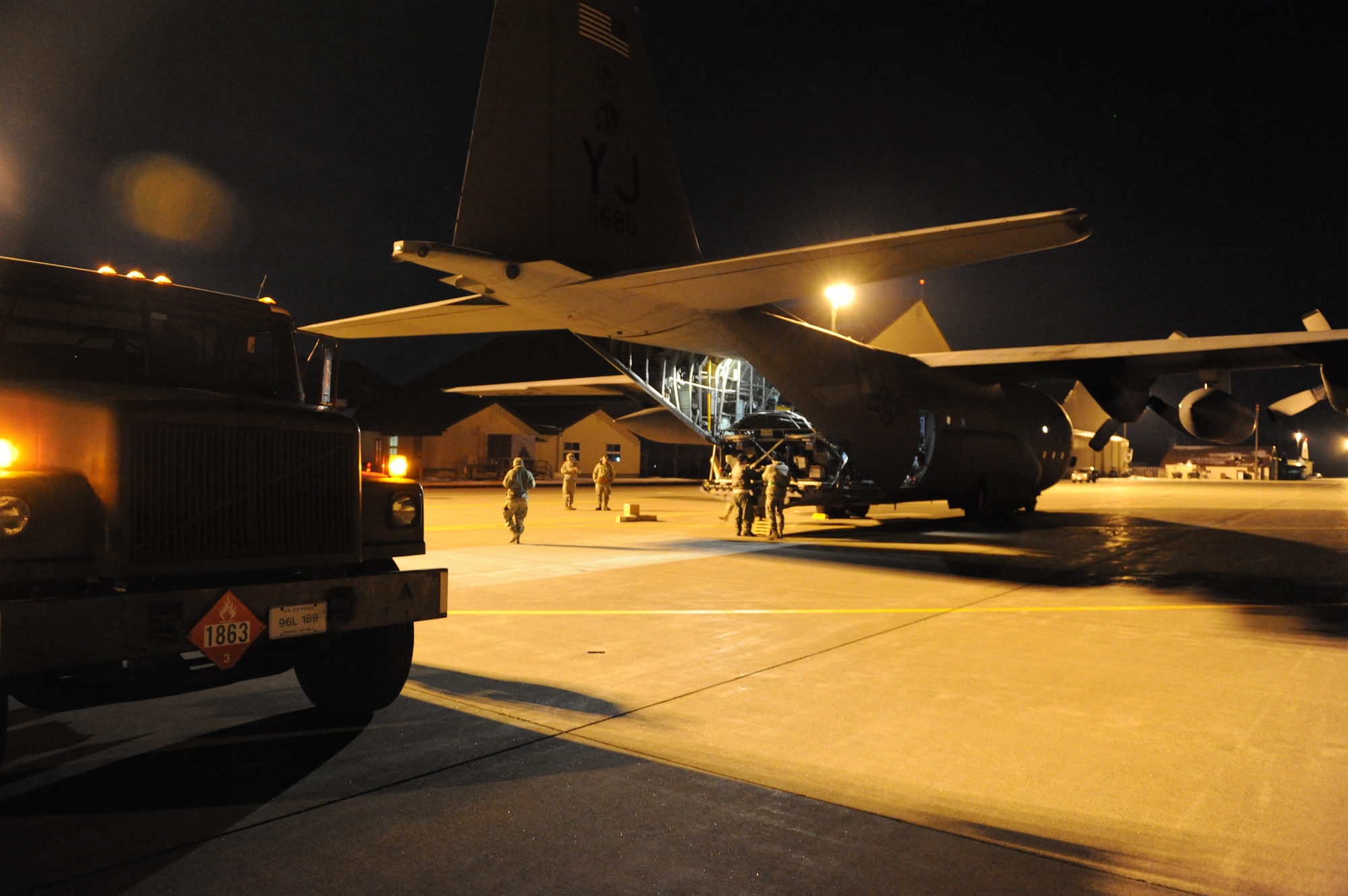 MISAWA AIR BASE, Japan–A fuel truck stands ready as a flight crew from Yokota Air Base prepares to unload fuel from A U.S. Air Force C-130 Hercules at here Mar 18. This is the third delivery of fuel in support of Operation Tomodachi. (U.S. Air Force Photo/Tech. Sgt. Russell J. McBride)

