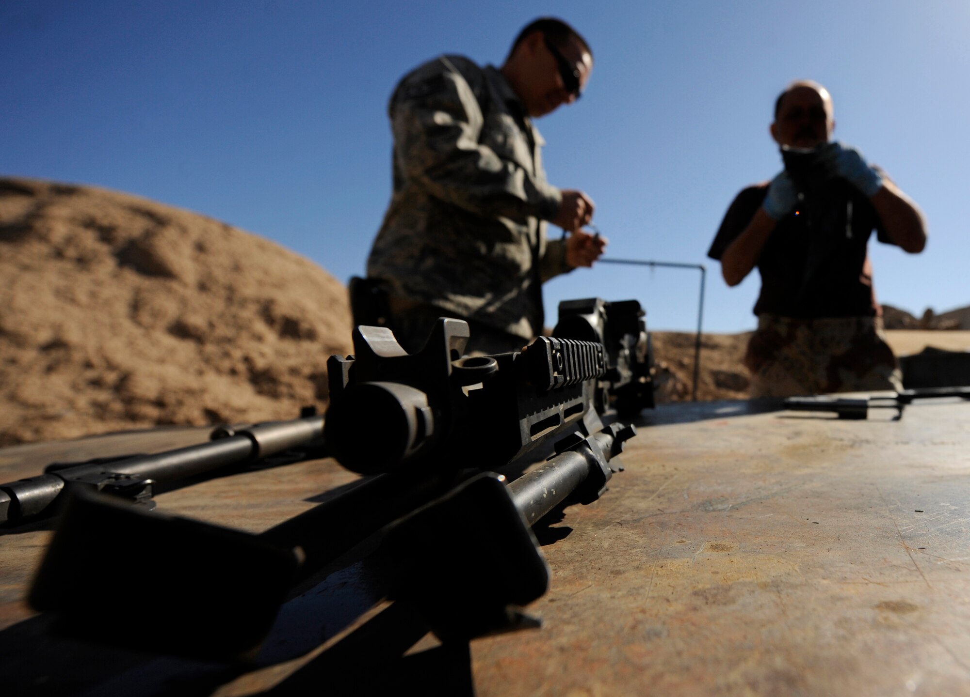 CAMP TAJI, Iraq -- Tech. Sgt. Bryan Felix, 721st Air Expeditionary Advisory Squadron weapons advisor, trains Iraqi Army Aviation Command soldiers, or 'jundees,' how to clean M240 machine guns. IqAAC and Iraq Training and Advisory Mission - Air advisors delivered about 30 M240 machine guns purchased by the Iraqi Ministry of Defense. Sergeant Felix is deployed from Hill Air Force Base, Utah, and calls Evansburg, Pa., his hometown. (U.S. Air Force/Tech. Sgt. Jason Lake)
