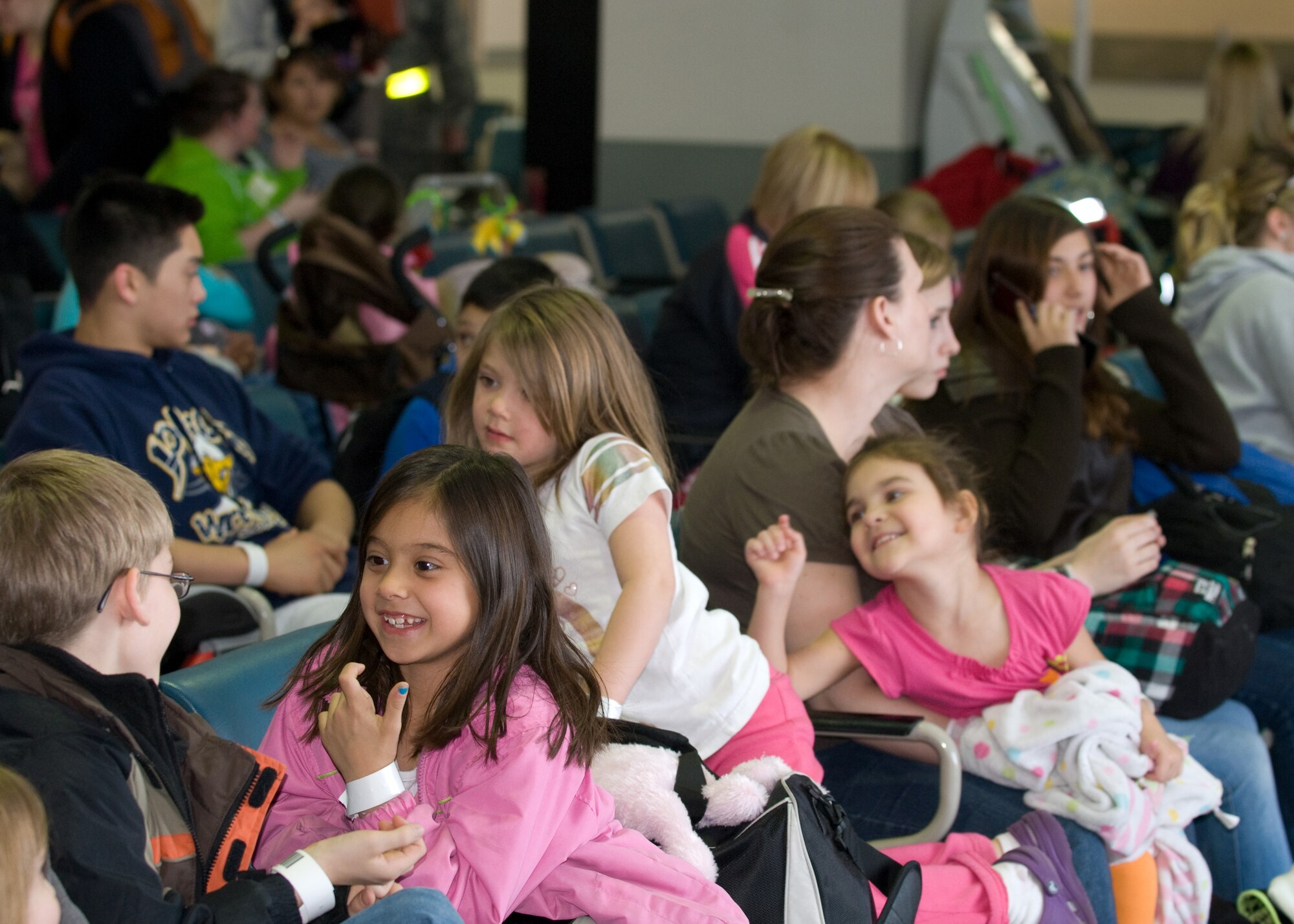 YOKOTA AIR BASE, Japan -- Military family members wait at the passenger terminal for their flight to Seattle here March 19. They are part of the first voluntary authorized departure flight from Yokota. (U.S. Air Force photo/Staff Sgt. Robin Stanchak) 