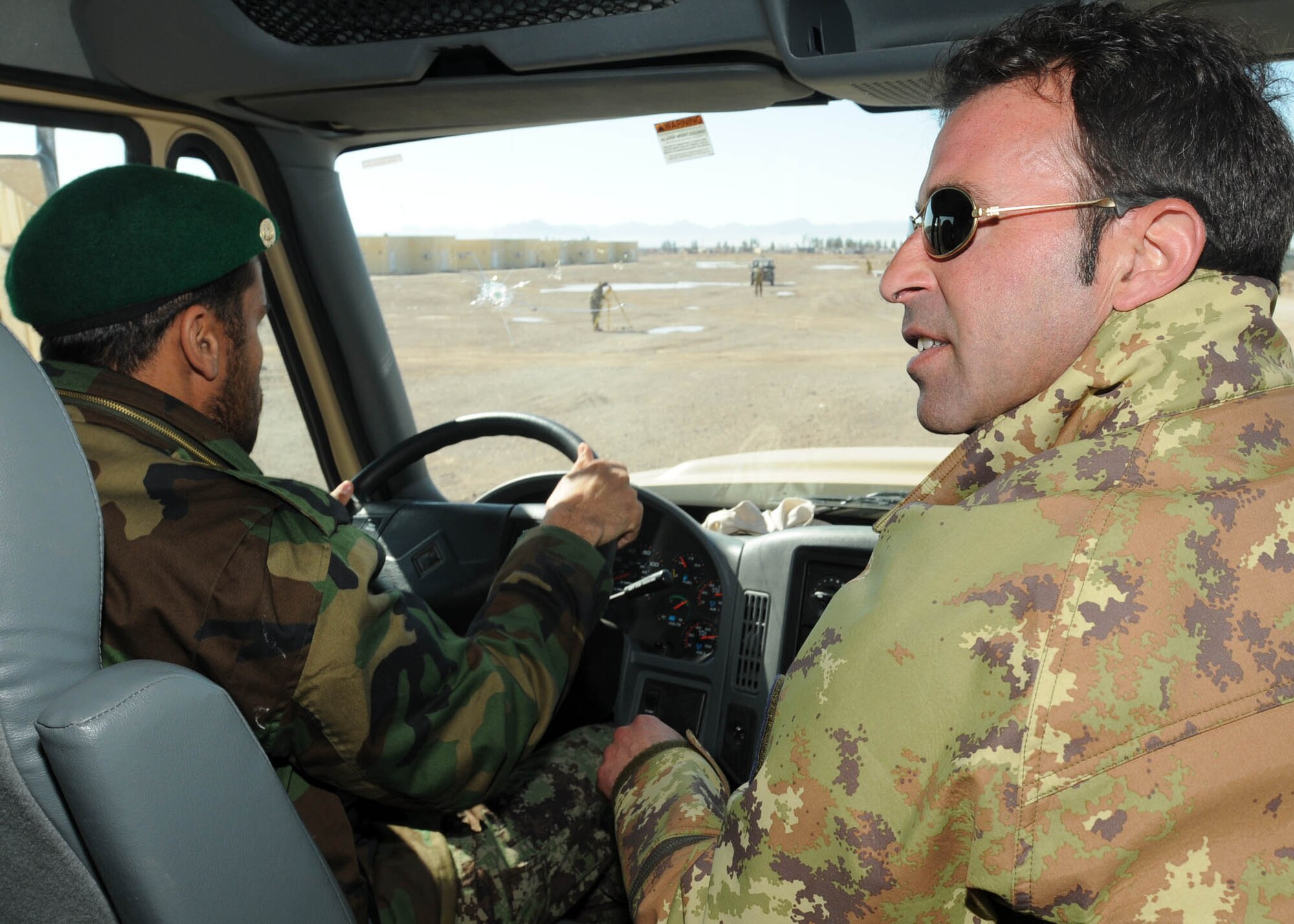 SHINDAND, Afghanistan - Italian air force service member with NATO Training Mission - Afghanistan/ 838th Air Expeditionary Advisory Group trains a member of the Afghan Air Force how to drive a truck in Shindand, Afghanistan. ( U.S. Navy photo by Mass Communications 3rd Class Jared E. Walker)


