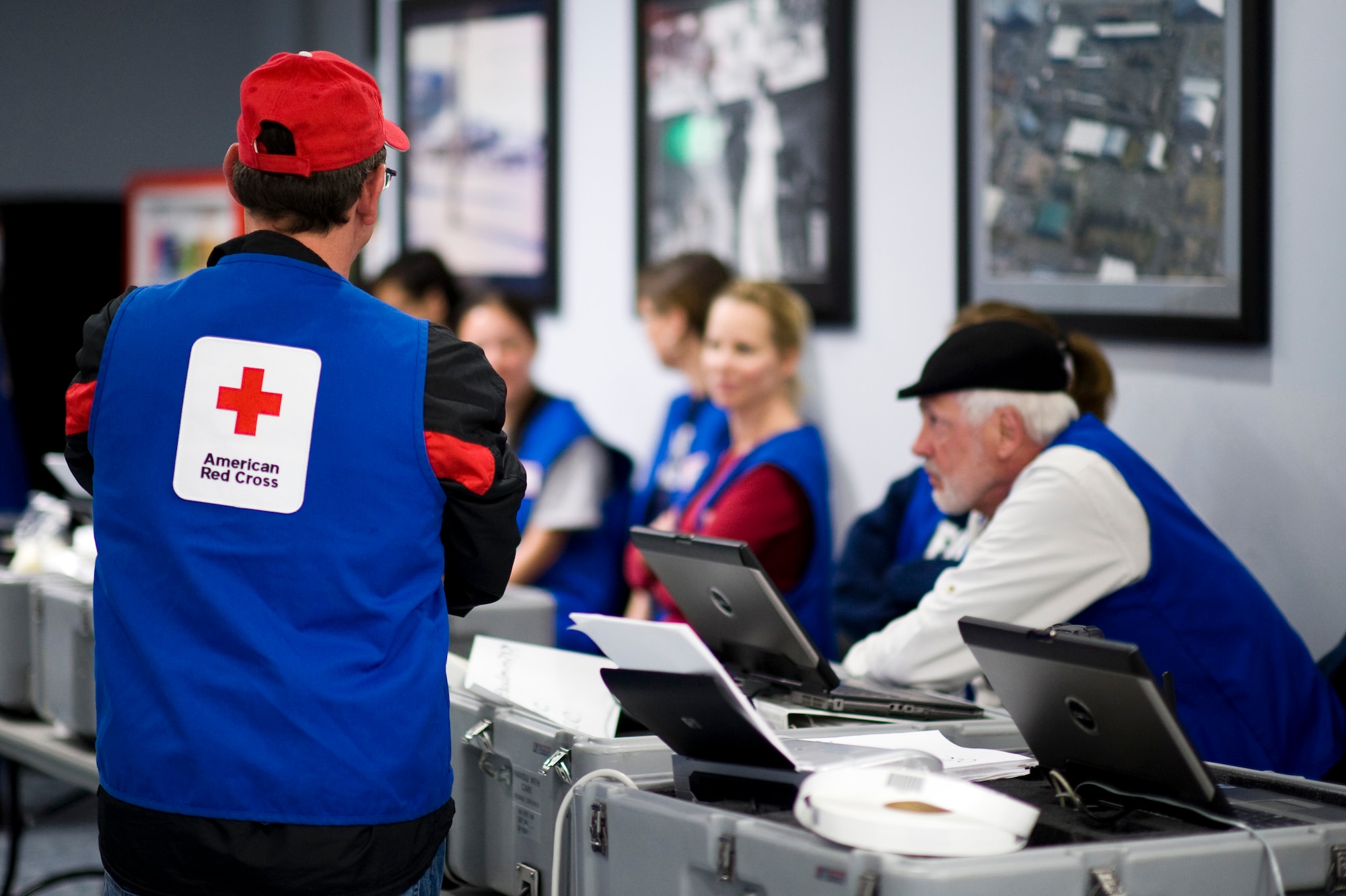 YOKOTA AIR BASE, Japan -- Red Cross volunteers standby to help with out-processing here, at the Taiyo Community Center, March 19. Military dependants participated in the first wave of voluntary authorized departures. These precautionary measures are intended to help ensure the safety of U.S. citizens during this dynamic time, as well as to assist and expedite Japanese recovery efforts by reducing the demand for food, water, fuel and electricity during this national emergency in Japan. (U.S. Air Force Photo/Staff Sgt. Samuel Morse)