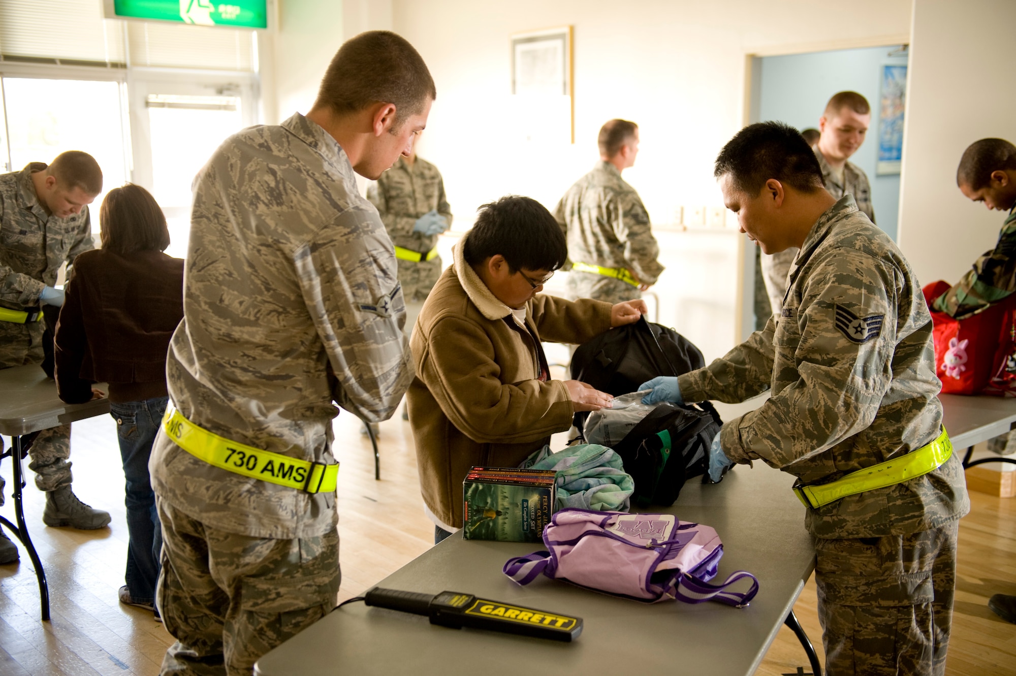 YOKOTA AIR BASE, Japan -- Members of the 730th Air Mobility Squadron conduct a baggage check during a large scale out-processing here, at the Taiyo Community Center, March 19. Military dependants participated in the first wave of voluntary authorized departures. These precautionary measures are intended to help ensure the safety of U.S. citizens during this dynamic time, as well as to assist and expedite Japanese recovery efforts by reducing the demand for food, water, fuel and electricity during this national emergency in Japan. (U.S. Air Force Photo/Staff Sgt. Samuel Morse)