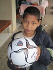 KORAT, Thailand - Worachai Buaban, nicknamed "Coke", holds a soccer ball donated by Airmen during a community outreach event to the Panyahukul Handicapped School in Korat, Thailand, March 18. The Airmen are participating in Exercise Cope Tiger 2011, an annual, multilateral, joint field training exercise currently being conducted at Korat and Udon Thani Royal Thai Air Bases March 14 through 25. (U.S. Air Force Photo/ Capt. Kirsten Udd)