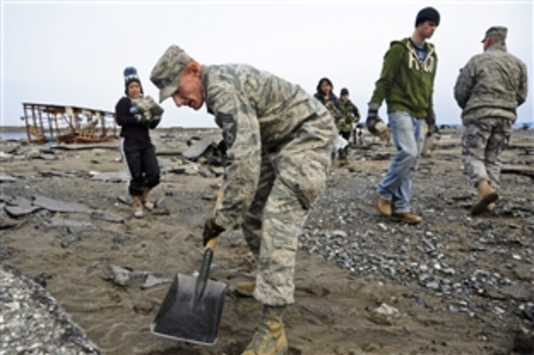 U.S. Air Force Chief Master Sgt. Matt Wickham uses a shovel to extract sidewalk bricks at the fishing port in Misawa, Japan, March 19, 2011. U.S. Service members, civilian employees and family members from Misawa Air Base joined with Misawa residents to clean up the port following an 8.9-magnitude earthquake and tsunami along Japan's eastern coast.
