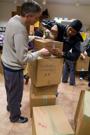 Station residents pack humanitarian aid donations in support of Operation Tomodachi here March 20.::r::::n::MCAS Iwakuni is an essential strategically located air and sea port supporting Operation Tomodachi as a::r::::n::logistical and resupply hub.