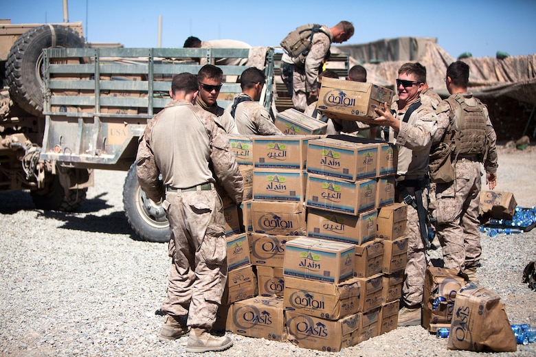 (From left to right) Lance Cpl. Michael Baker, a driver for Shaker Mobile, Fox Company, 2nd Battalion, 3rd Marine Regiment, and Lance Cpl. Joshua Beier, a turret gunner with Shaker Mobile, unload water at a patrol base in northern Marjah, Helmand province, Afghanistan, March 19.