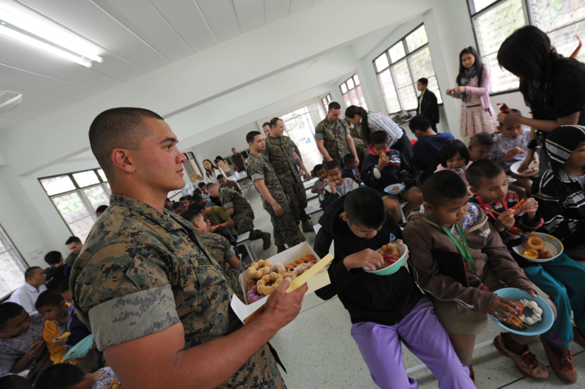 U.S. Marine Lance Corporal Samuel Roberto, a native of Santa Rita, Guam, helps pass out food to the students of the School for the Blind Education Service Center on March 18 in Korat, Thailand, during a break from Cope Tiger 2011, an annual, multilateral, joint field training exercise currently being conducted at Korat and Udon Thani Royal Thai Air Bases March 14 through 25. Participants of Cope Tiger include the U.S. Air Force, the U.S. Marine Corps, the Royal Thai Air Force, Royal Thai Army, and the Republic of Singapore Air Force.  LCPL Roberto is a maintenance mechanic and currently assigned to the Marine All-Weather Fighter Attack Squadron 533, Marine Corps Air Station Iwakuni, Japan.  (U.S.  Air Force photo/Master Sgt. Cohen A. Young)