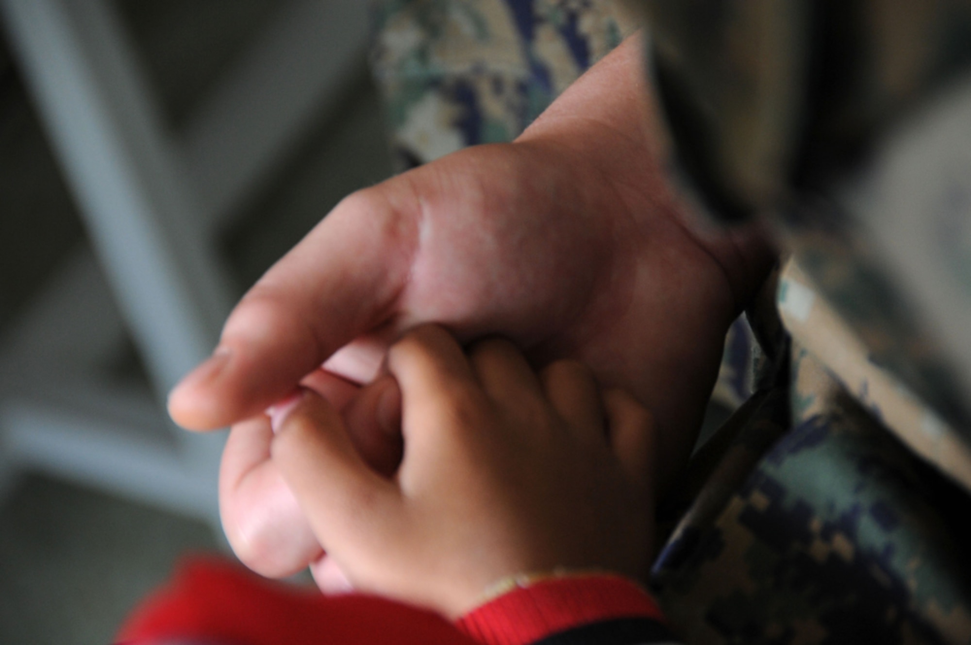 While at the School for the Blind Education Service Center on March 18 in Korat, Thailand, a student holds the hand of a U.S. Marine from the All-Weather Fighter Attack Squadron 533, Marine Corps Air Station Iwakuni, Japan, during Cope Tiger 2011, an annual, multilateral, joint field training exercise currently being conducted at Korat and Udon Thani Royal Thai Air Bases March 14 through 25. Participants of Cope Tiger include the U.S. Air Force, the U.S. Marine Corps, the Royal Thai Air Force, Royal Thai Army, and the Republic of Singapore Air Force. (U.S.  Air Force photo/Master Sgt. Cohen A. Young)