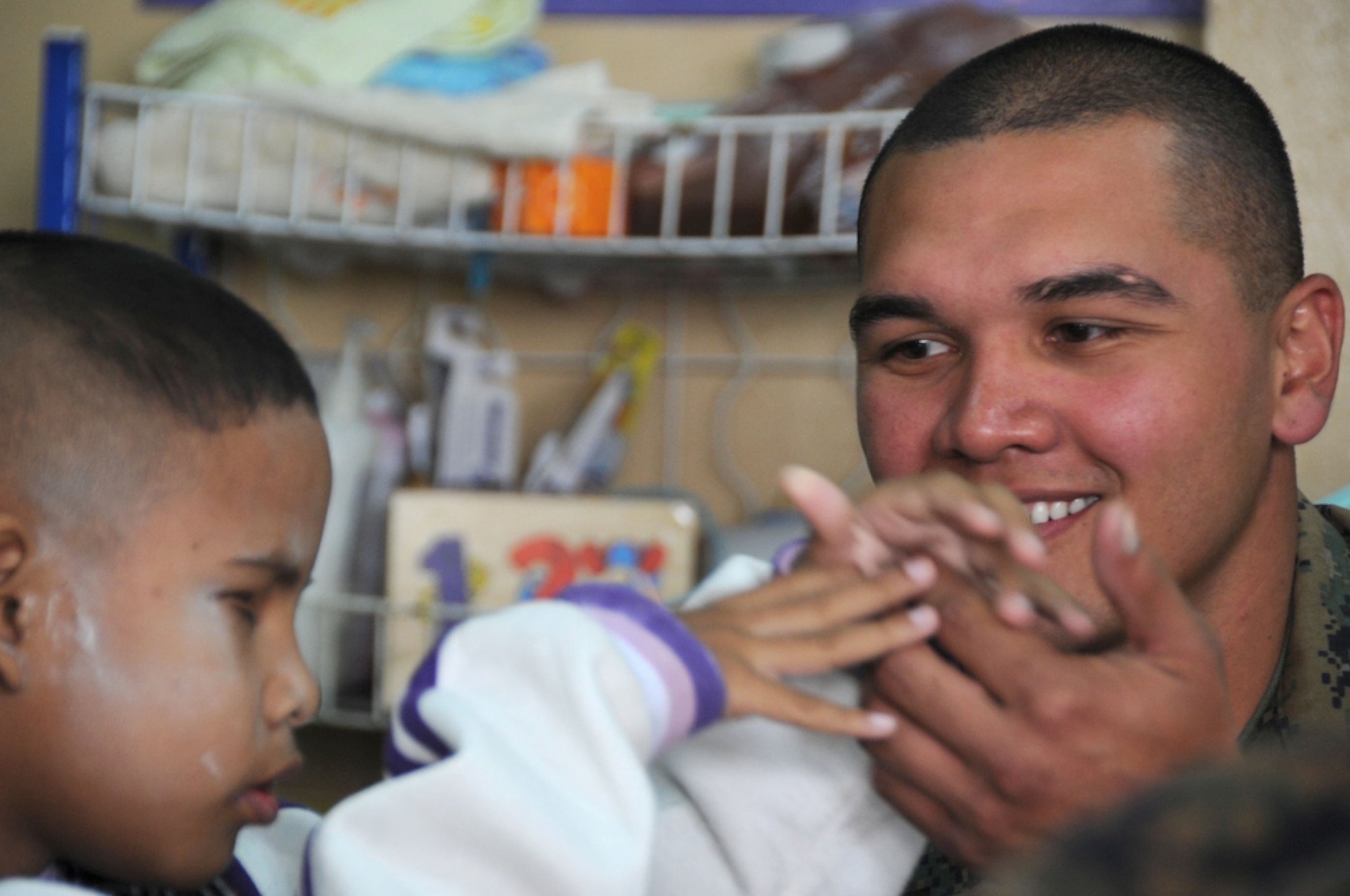 U.S. Marine Lance Corporal Samuel Roberto, a native of Santa Rita, Guam allows a young, blind Thai boy an opportunity to feel his hand as a form of sight during a visit to the School for the Blind Education Service Center on March 18 in Korat, Thailand during Cope Tiger 2011,  an annual, multilateral, joint field training exercise currently being conducted at Korat and Udon Thani Royal Thai Air Bases March 14 through 25. Participants of Cope Tiger include the U.S. Air Force, the U.S. Marine Corps, the Royal Thai Air Force, Royal Thai Army, and the Republic of Singapore Air Force.  LCPL Roberto is a maintenance mechanic and currently assigned to the Marine All-Weather Fighter Attack Squadron 533, Marine Corps Air Station Iwakuni, Japan.  (U.S.  Air Force photo/Master Sgt. Cohen A. Young)