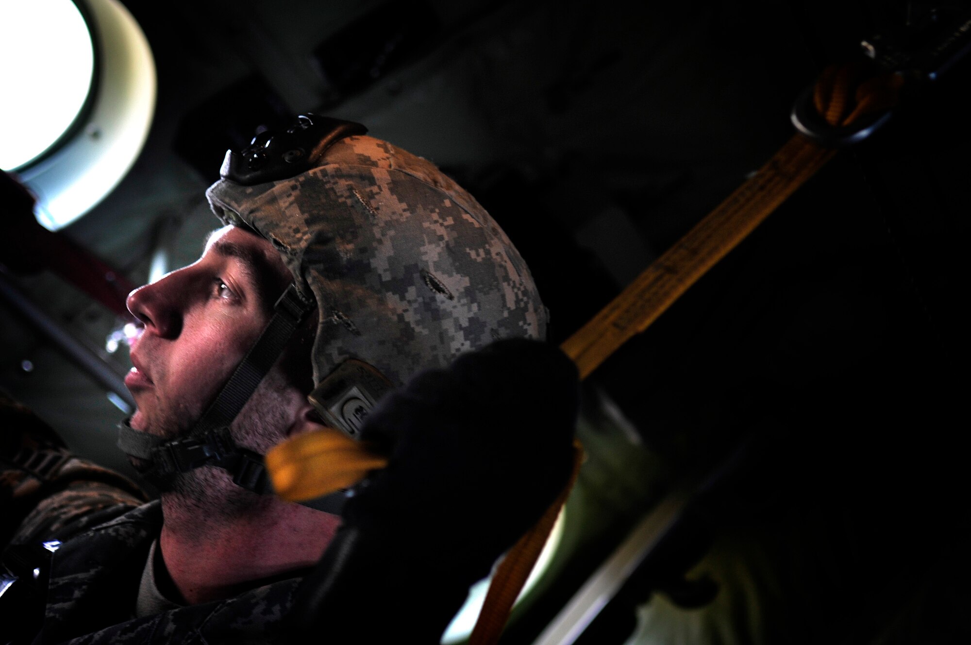 U.S. Air Force Staff Sgt. Stephen Baker, 435th Security Forces Squadron, jumpmaster, stands with his parachute hooked onto a static line of a C-130J in preparation of a joint jump between U.S. and Romanian paratroopers over a landing zone near Campia Turzii, Romania, March 18, 2011.  This jump was conducted as a part of Carpathian Spring 2011, a building partnership capacity exercise where members of U.S. military joined their Romanian counterparts to learn from one another and strengthen alliances. (U.S. Air Force Photo by Tech Sgt. Jocelyn L. Rich)(released)