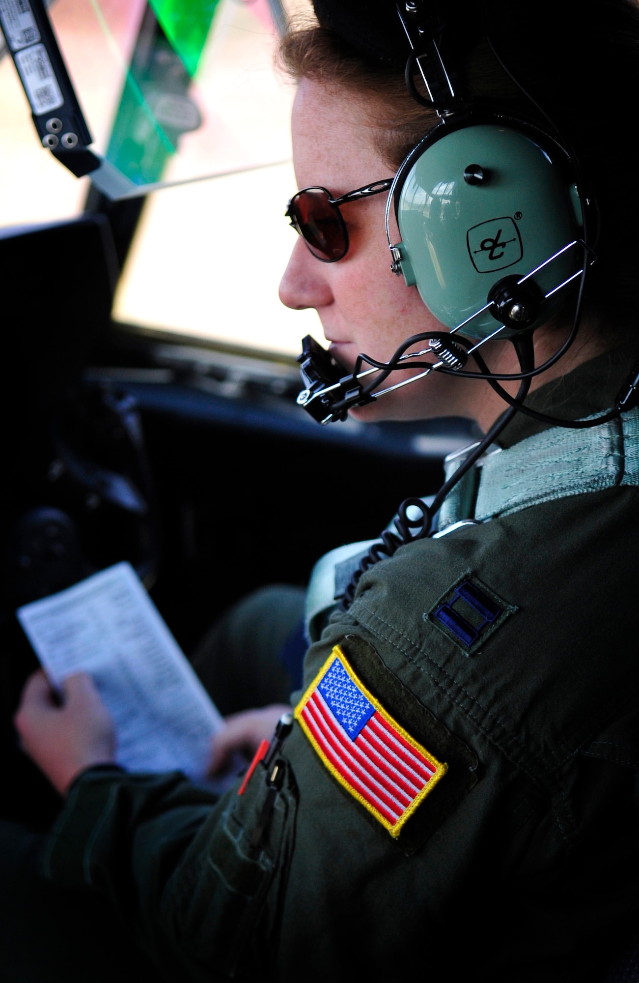 U.S. Air Force Capt. Marcie Walton, 37th Airlift Squadron, pilot, runs a check list in preparation of a personnel drop of paratroopers over a landing zone near Campia Turzii, Romania, March 18, 2011.  This jump was conducted as a part of Carpathian Spring 2011, a building partnership capacity exercise where members of U.S. military joined their Romanian counterparts to learn from one another and strengthen alliances. (U.S. Air Force Photo by Tech Sgt. Jocelyn L. Rich)(released)