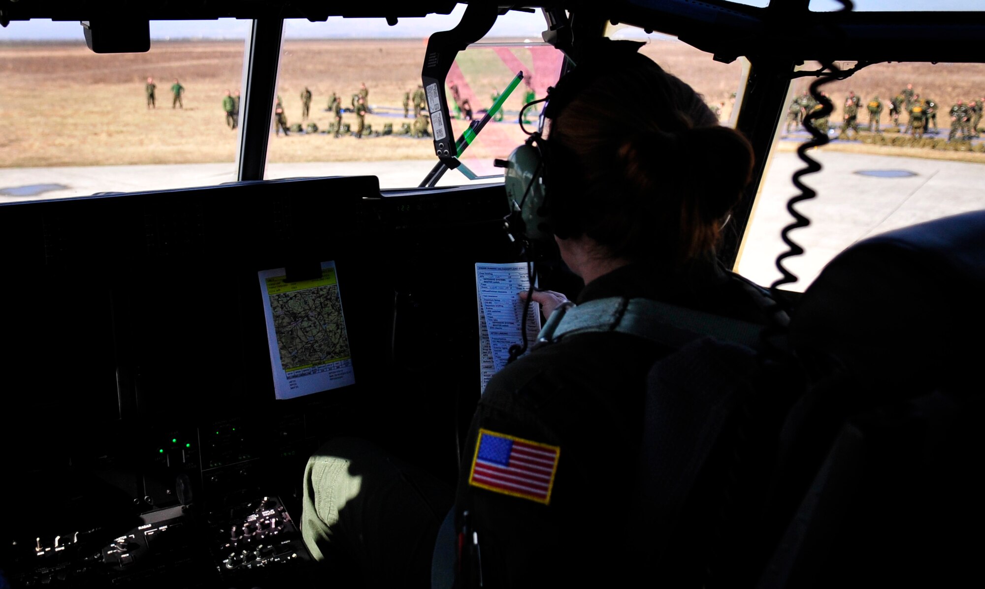 U.S. Air Force Capt. Marcie Walton, 37th Airlift Squadron, pilot, prepares to pick up static line and free-fall paratroopers in a C-130J at Campia Turzii, Romania, March 18, 2011.  This jump was conducted as a part of Carpathian Spring 2011, a building partnership capacity exercise where members of U.S. military joined their Romanian counterparts to learn from one another and strengthen alliances. (U.S. Air Force Photo by Tech Sgt. Jocelyn L. Rich)(released)