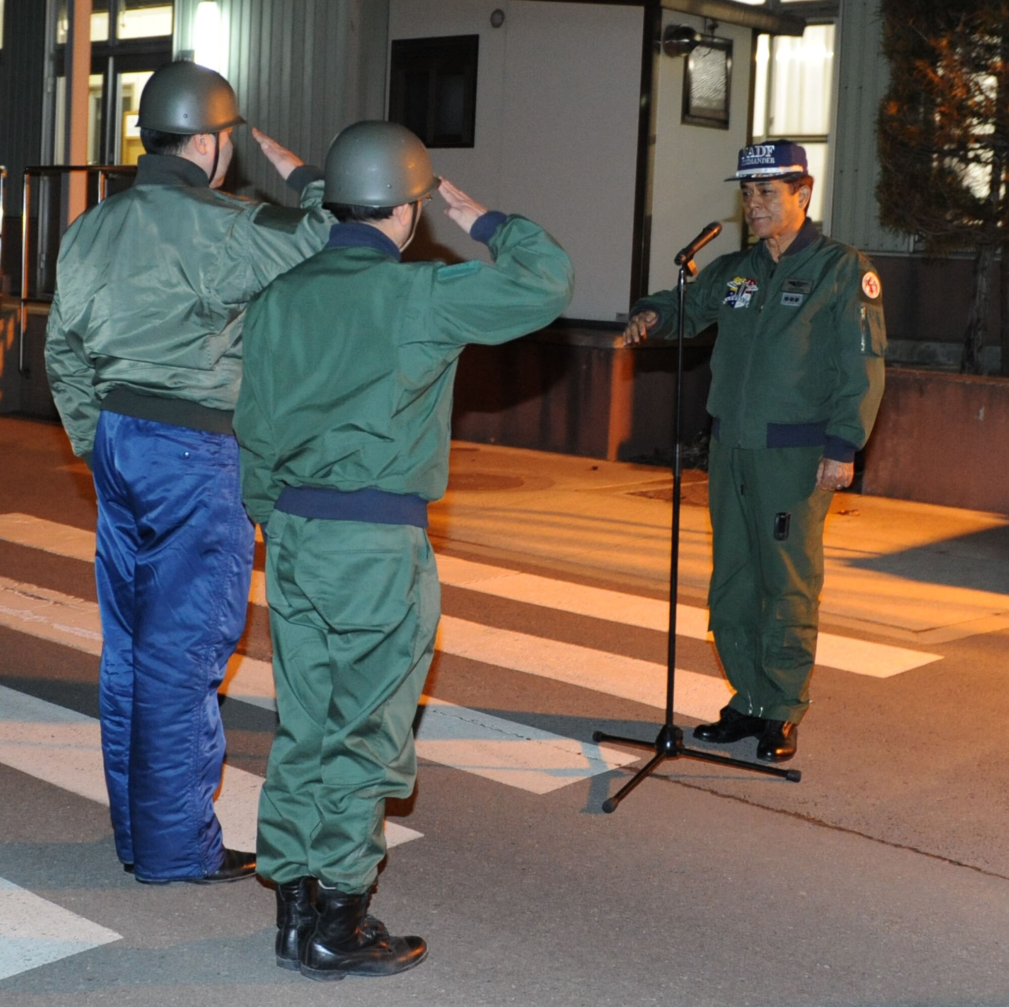 MISAWA AIR BASE, Japan – Japanese Air Self-Defense Force Lt. Col. Tsuyoshi Kujuro, 2nd Disaster Relief Team leader, and his subordinate report in to JASDF
Lt Gen Harukazu Saitou, Northern Air Defense Force commander, Mar. 19. The disaster relief team was preparing to depart for Yamada in support of the earthquake and tsunami disasters. (U.S. Air Force Photo/Tech. Sgt. Russell J. McBride)