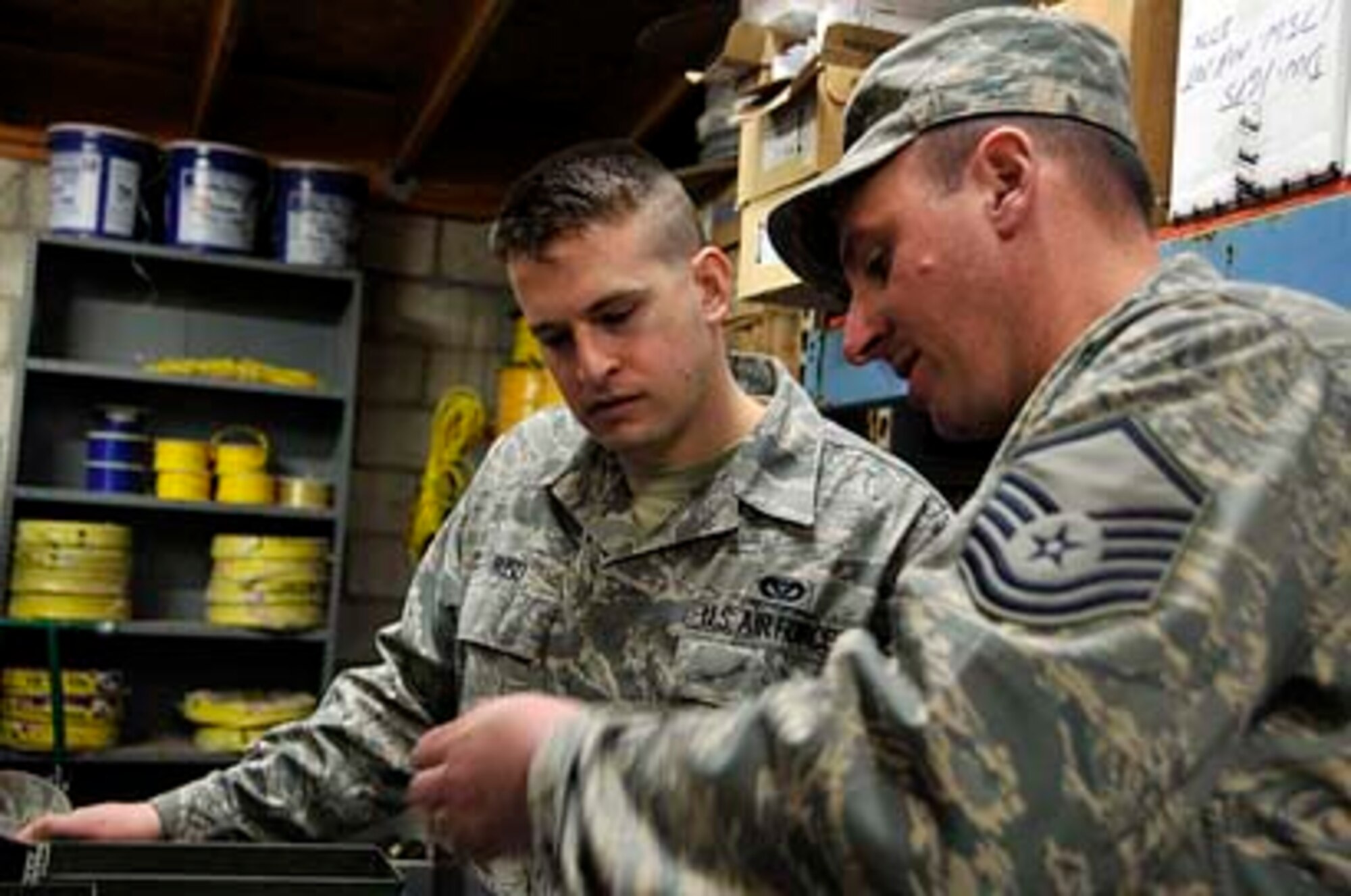 SAN CLEMENTE ISLAND, Calif -- Master Sgt. Tom Bradley, an electrical supervisor with the 176th Civil Engineer Squadron, teaches some tools of the trade to Senior Airman John Buso, an electrician from the unit.

In March 2011, the 176 CES deployed to this remote location off the coast of southern California for two weeks to train and work on a variety of infrastructure projects. 

Alaska Air National Guard photo by Staff Sgt. N. Alicia Goldberger.
