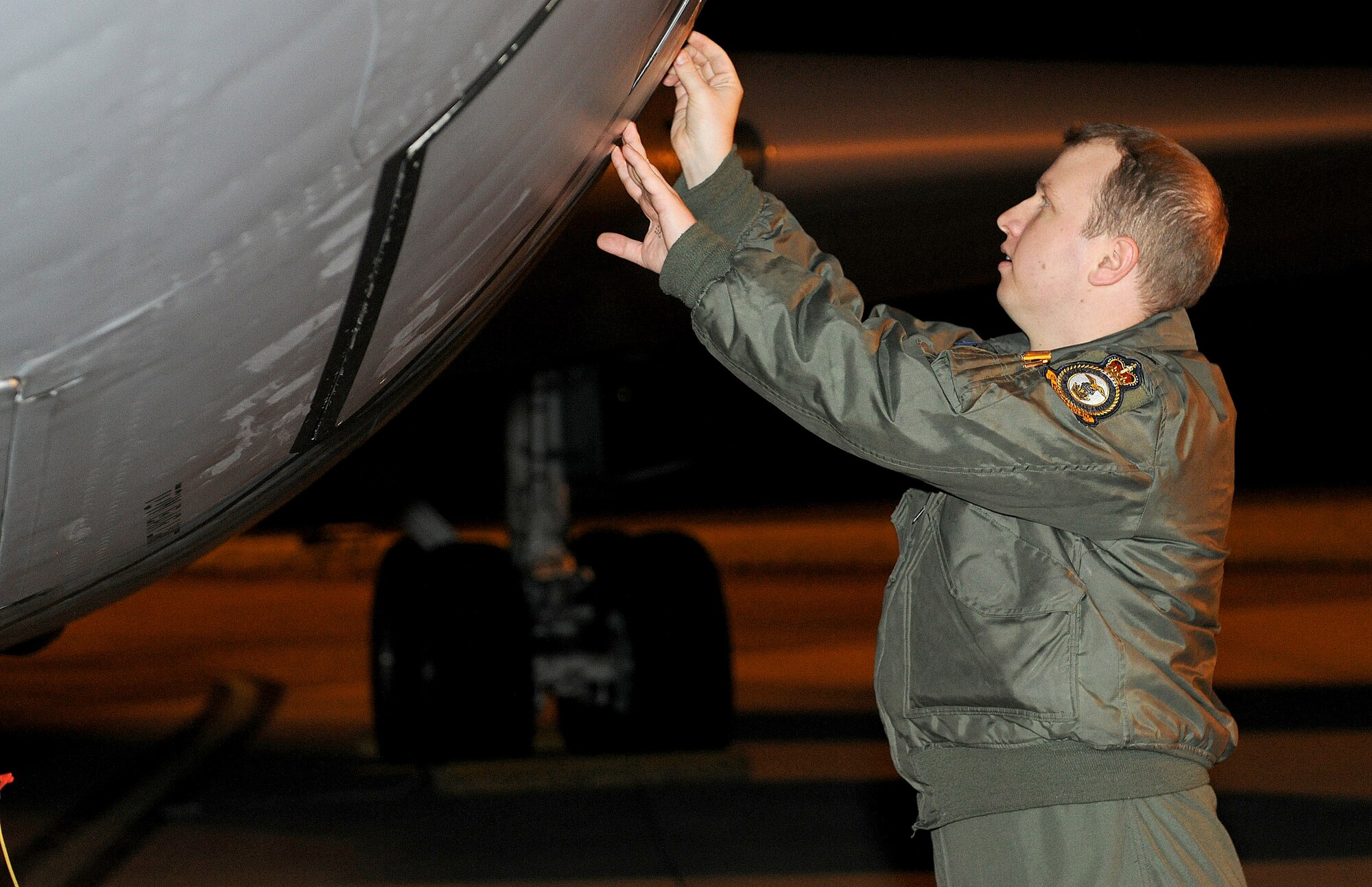 RAF MILDENHALL, England -- A crew member from the 351st Air Refueling Squadron removes an inspection seal from a KC-135 Stratotanker before boarding for a refueling mission in support of Joint Task Force Odyssey Dawn. JTF Odyssey Dawn is the U.S. Africa Command task force established to provide operational and tactical command and control of U.S. military forces supporting the international response to the unrest in Libya and enforcement of United Nations Security Council Resolution (UNSCR) 1973. UNSCR 1973 authorizes "all necessary measures" to protect civilians in Libya under threat of attack by Gadhafi regime forces. JTF Odyssey Dawn is commanded by U.S. Navy Admiral Sam Locklear. (U.S. Air Force photo by Senior Airman Tabitha M. Lee)