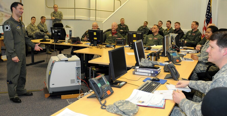 RAF MILDENHALL, England -- Leadership from the 100th Air Refueling Wing are briefed in the Installation Command Center on current operations supporting Joint Task Force Odyssey Dawn. JTF Odyssey Dawn is the U.S. Africa Command task force established to provide operational and tactical command and control of U.S. military forces supporting the international response to the unrest in Libya and enforcement of United Nations Security Council Resolution (UNSCR) 1973. UNSCR 1973 authorizes "all necessary measures" to protect civilians in Libya under threat of attack by Qadhafi regime forces. JTF Odyssey Dawn is commanded by U.S. Navy Admiral Sam Locklear. (U.S. Air Force photo by Senior Airman Tabitha M. Lee) (Image masked for operational security)