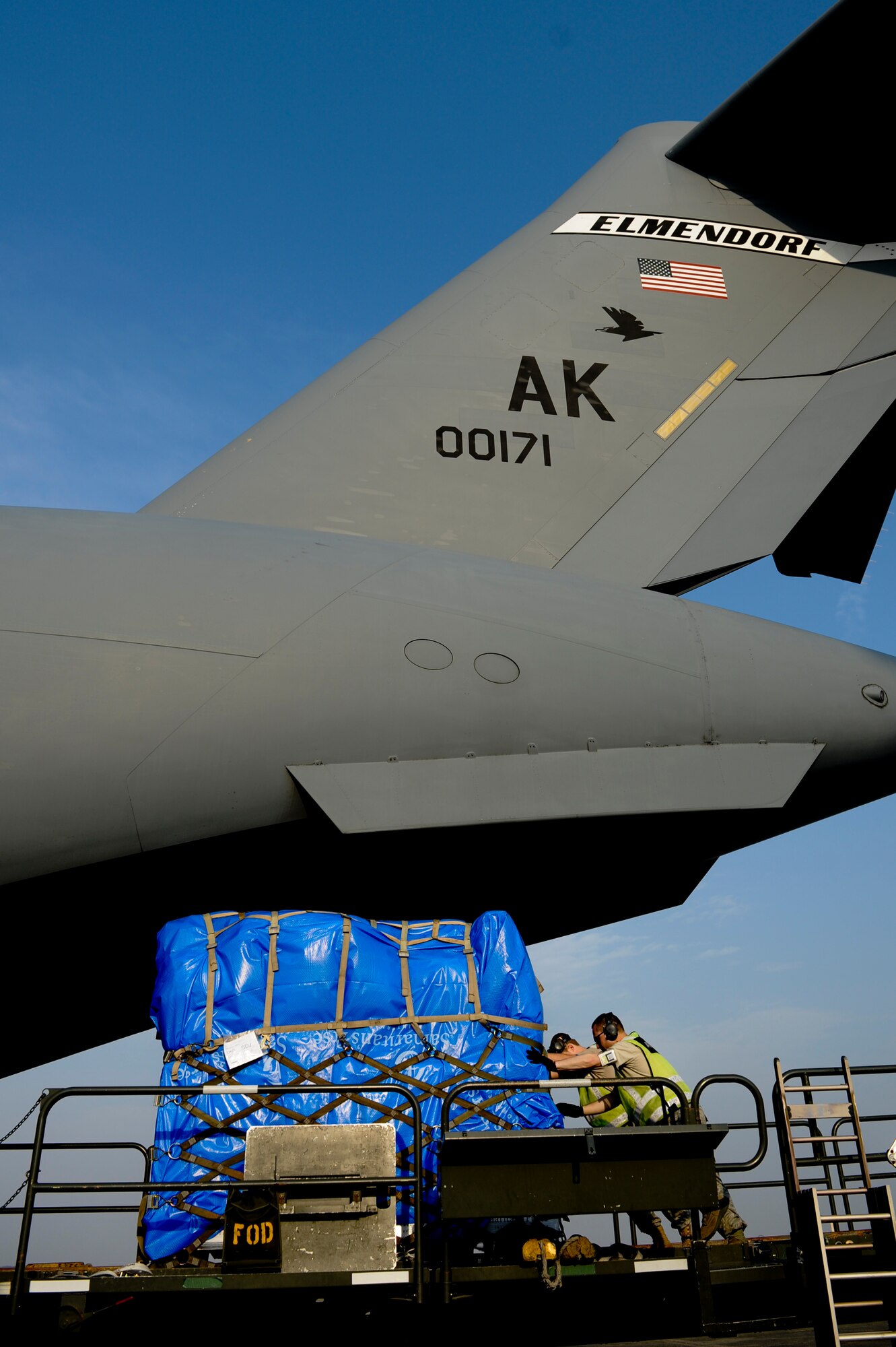 YOKOTA AIR BASE, Japan -- Staff Sgt. Jason Doyle and Senior Airman Joshua Buckner, 730th Air Mobility Squadron, moves supplies onto a C-17 Globemaster III March 20. The supplies were transported to Sendai Airport to be used for humanitarian assistance bringing relief to Japan after the earthquake and tsunami disaster. (U.S. Air Force photo/Staff Sgt. Jonathan Steffen)